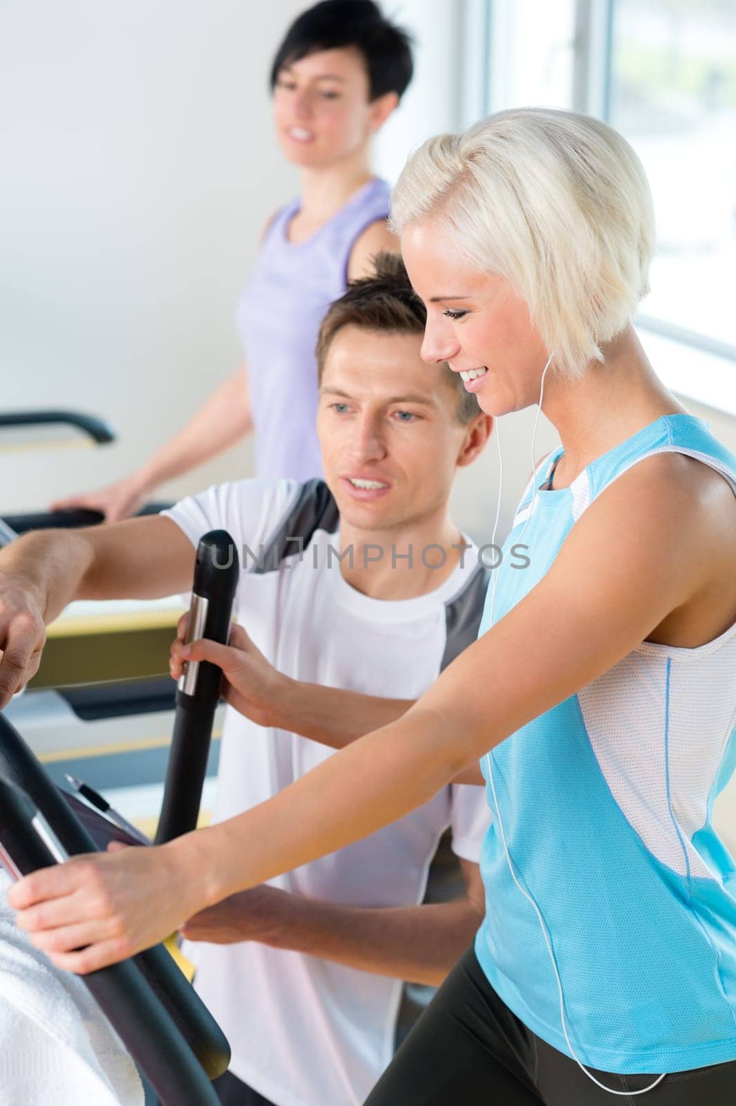 Walking on treadmill young people cardio workout at fitness center