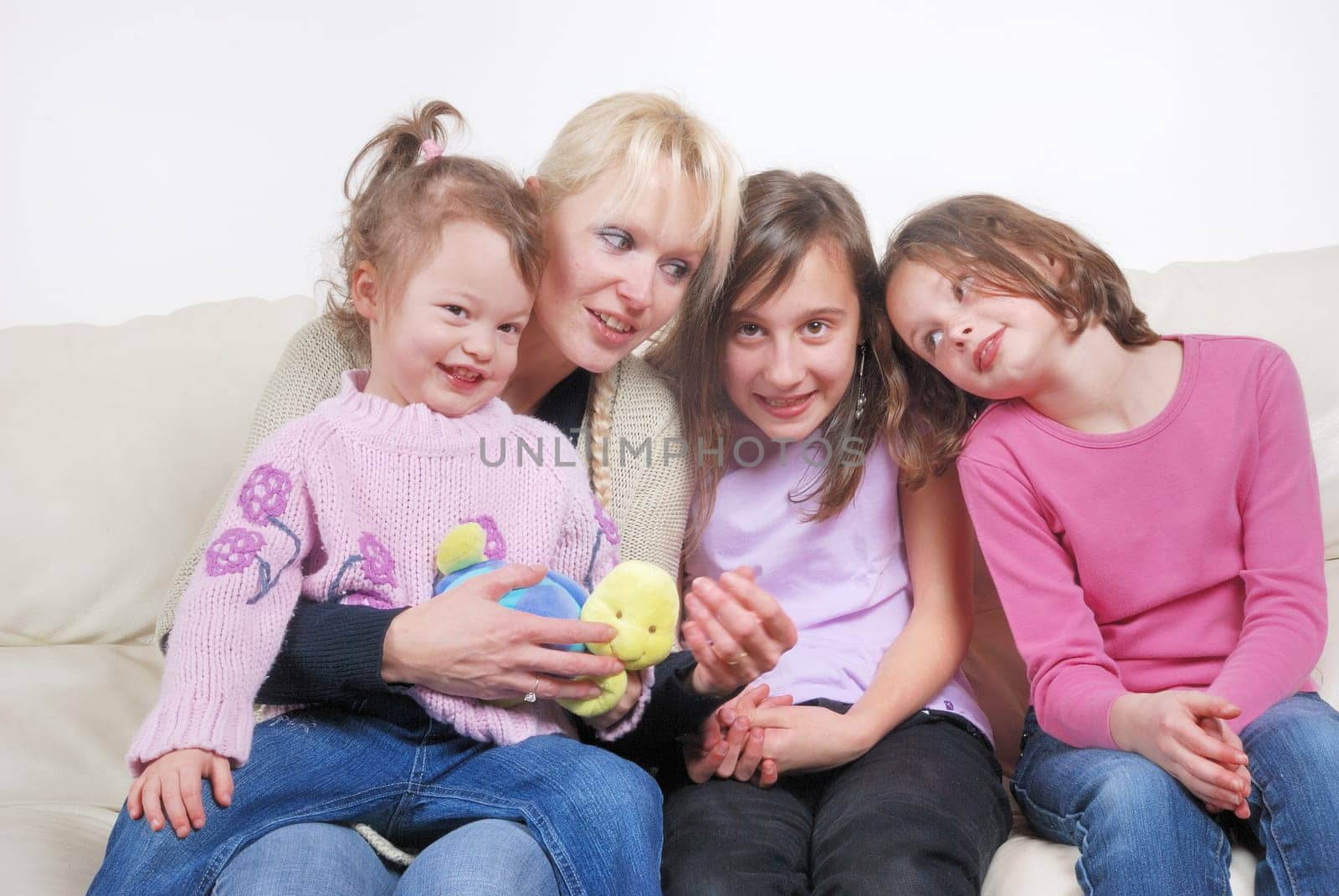 Family sitting in living room on sofa