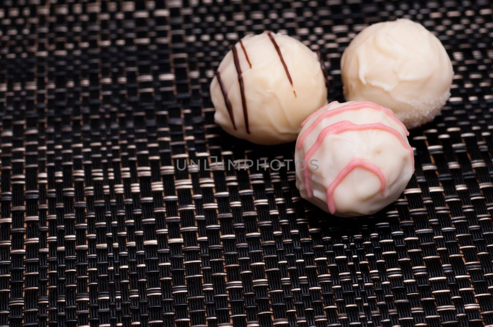 White chocolate truffle pralines on a dark background