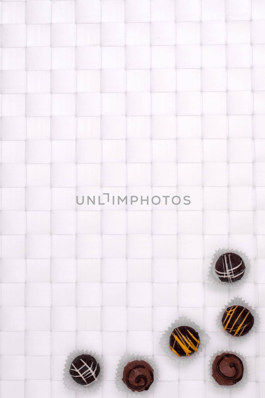 Brown Truffle Chocolates on a White Braided Background