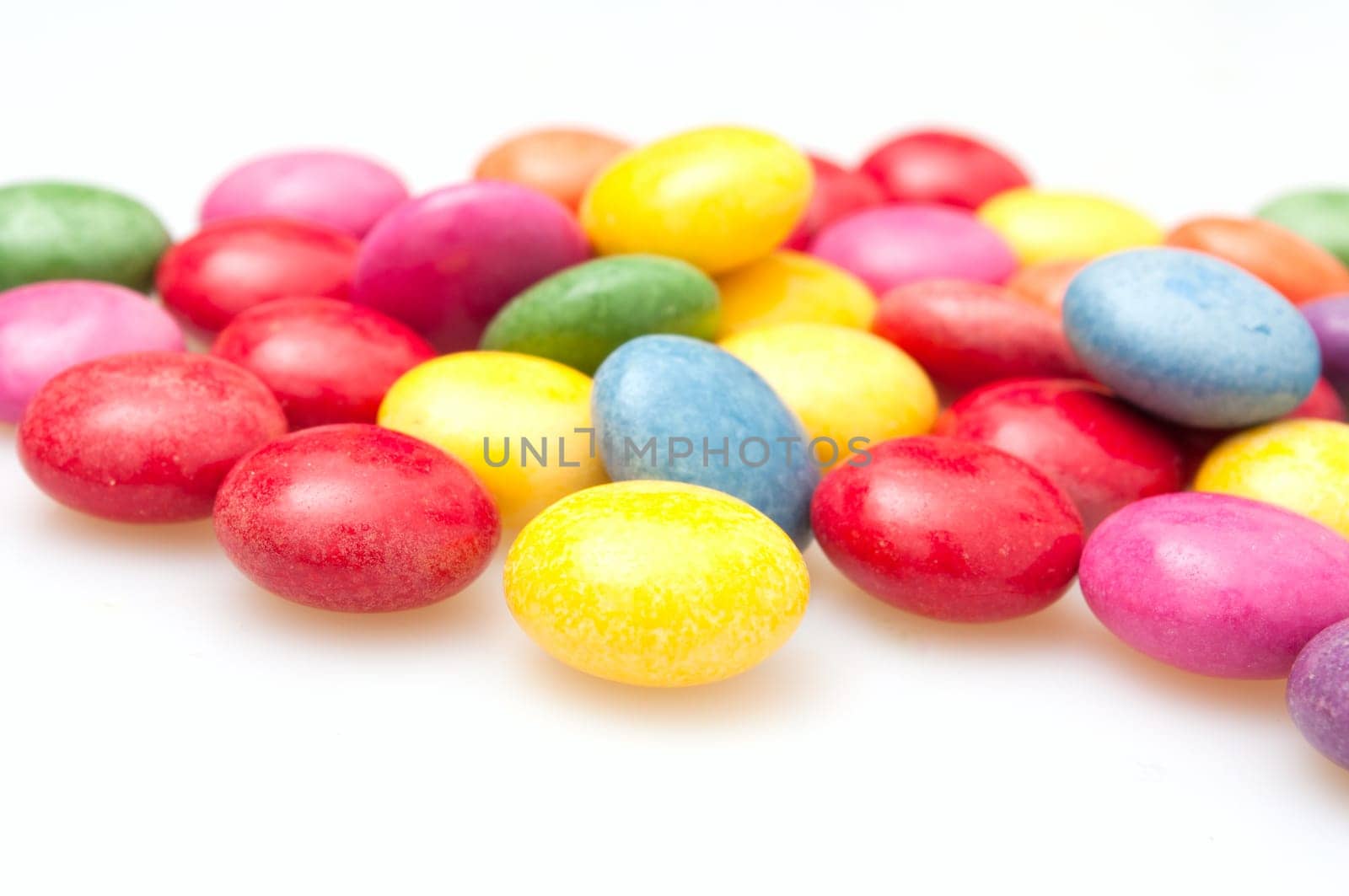 Round Candies in Many Colors on White Background