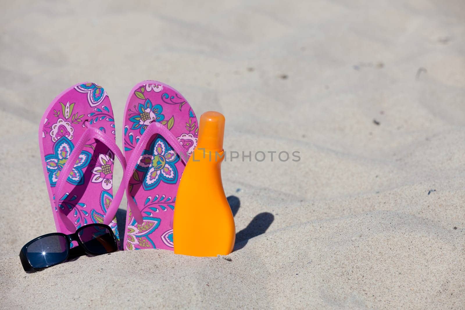 Slippers stuck in the sand on the Baltic Sea