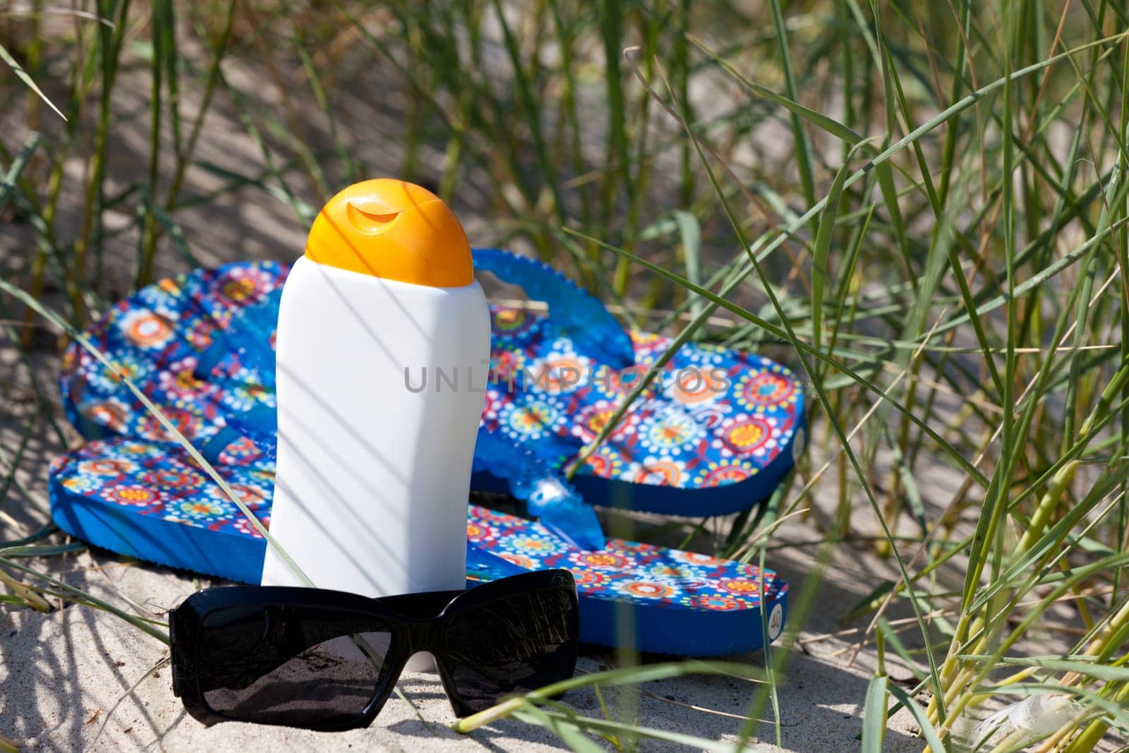 Flip-flops and sunglasses in the dune
