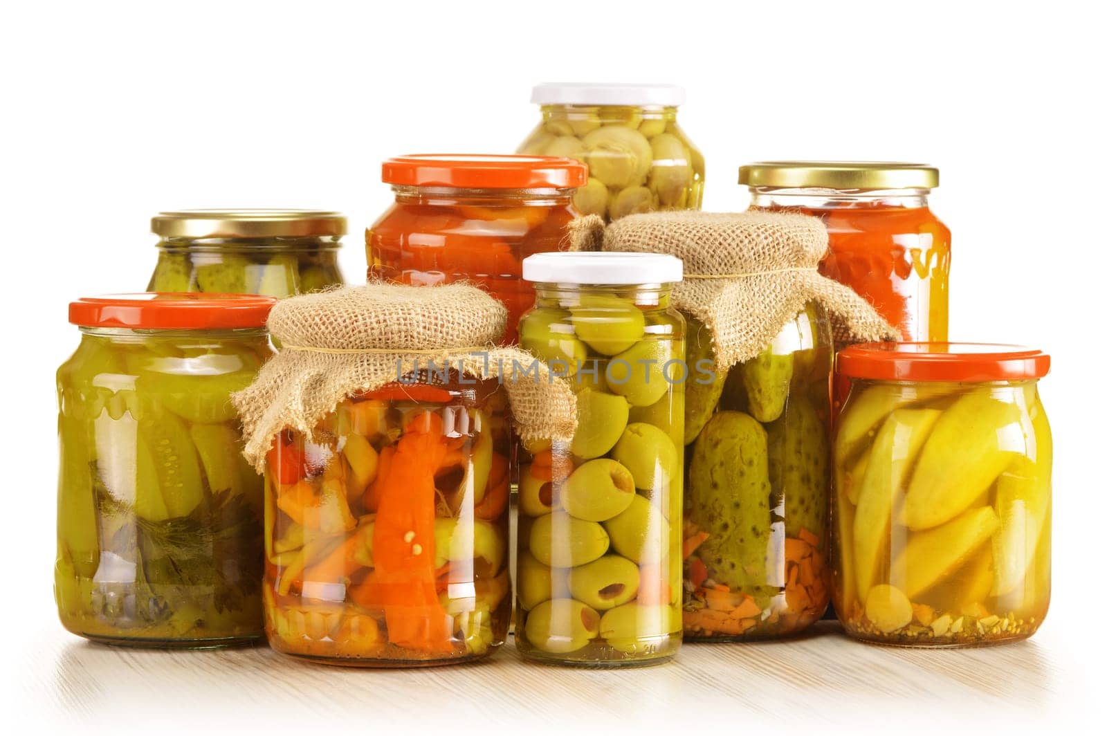 Composition with jars of pickled vegetables. Marinated food.