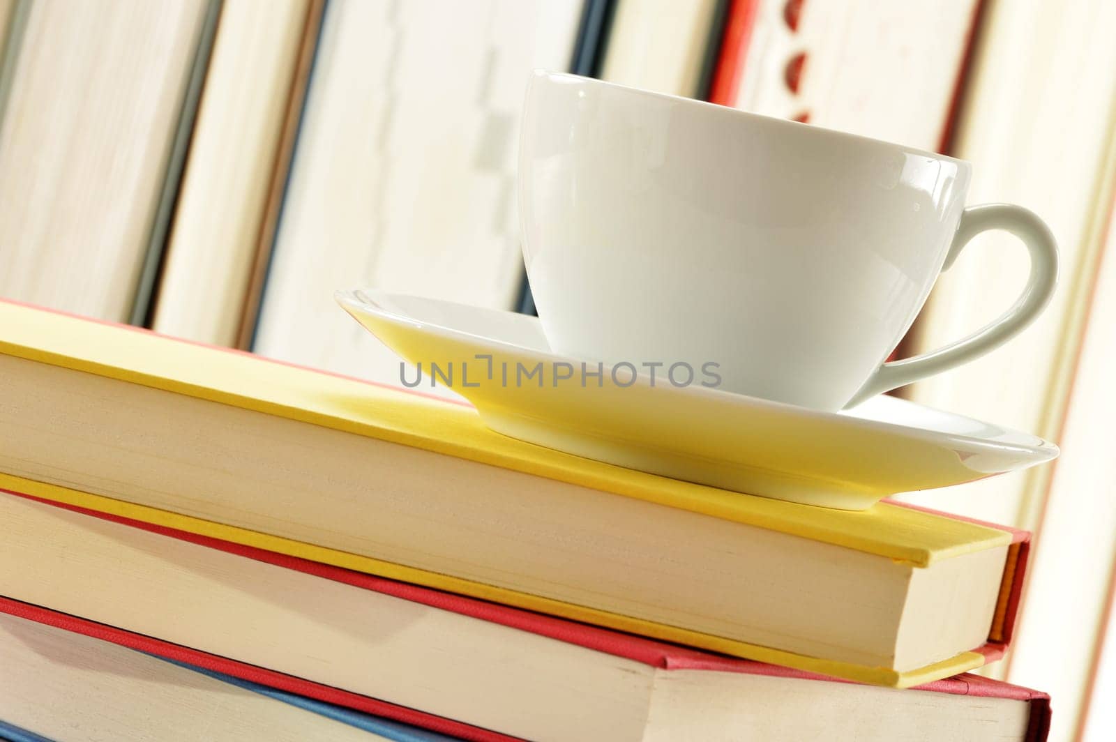 Composition with stack of books and cup of coffee