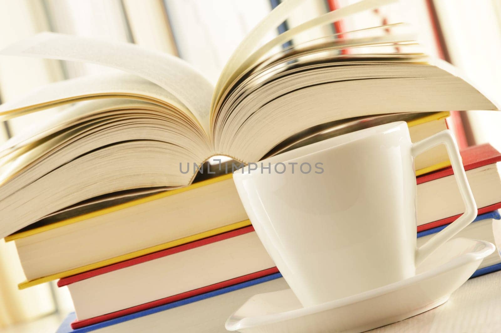 Composition with stack of books and cup of coffee