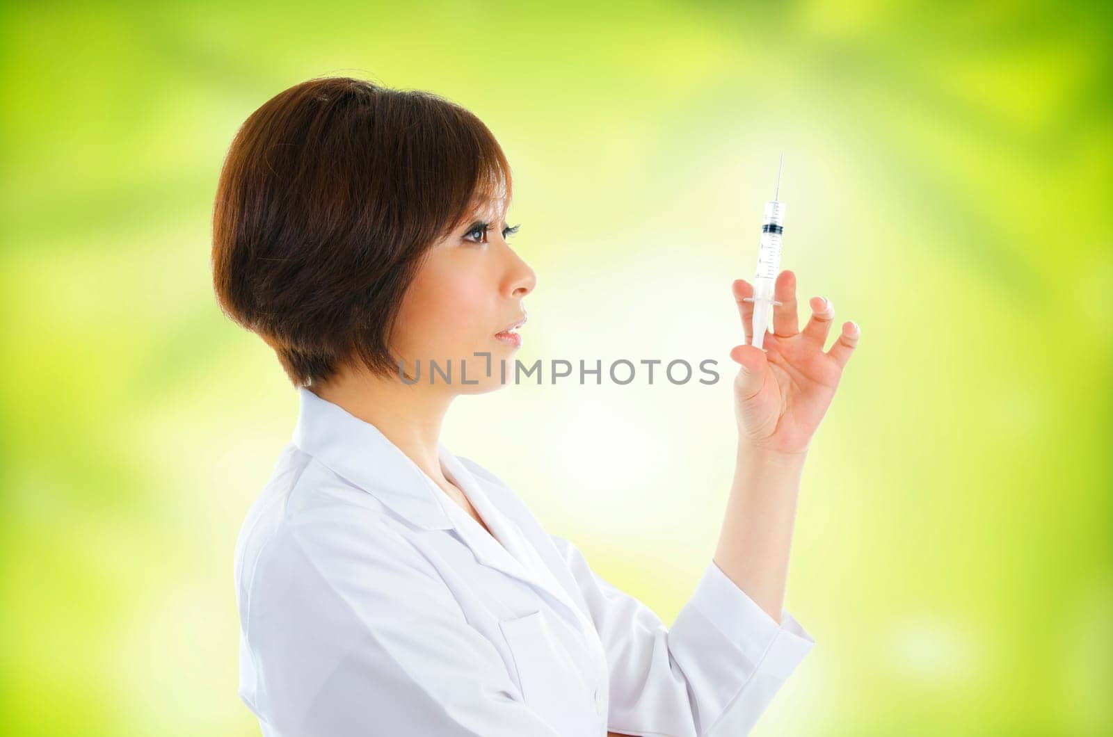 Asian beautician with syringe on green background