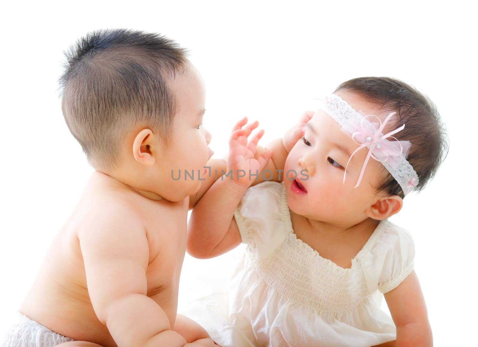 Two Asian babies having baby talk