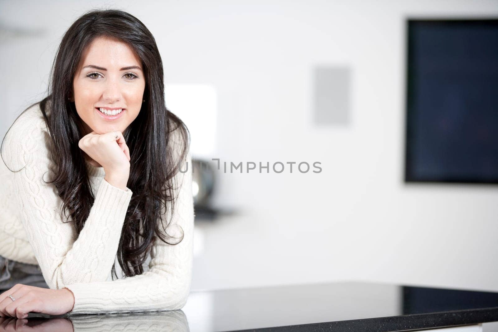 Young woman relaxing in the kitchen at home