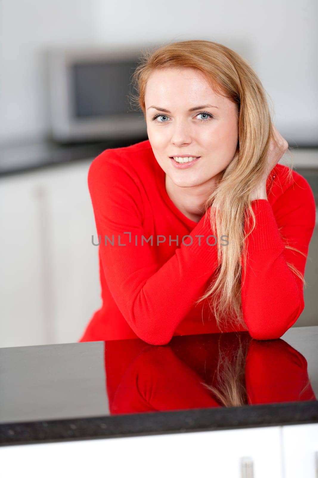 Young woman relaxing in the kitchen at home