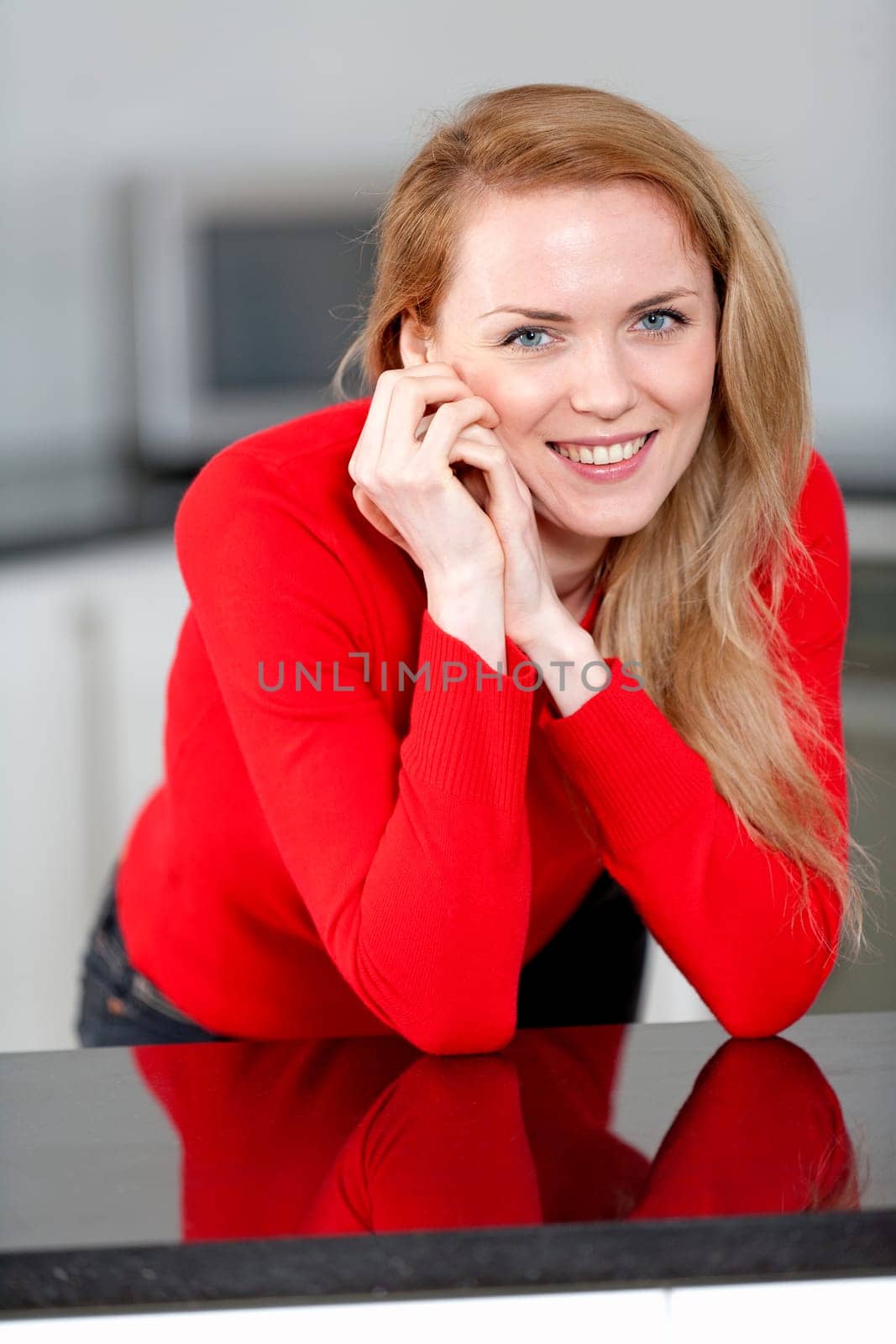 Young woman relaxing in the kitchen at home