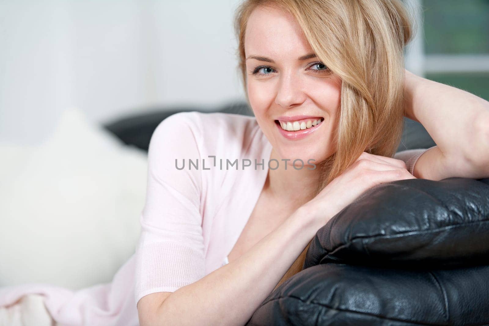 Young woman lying on sofa at home