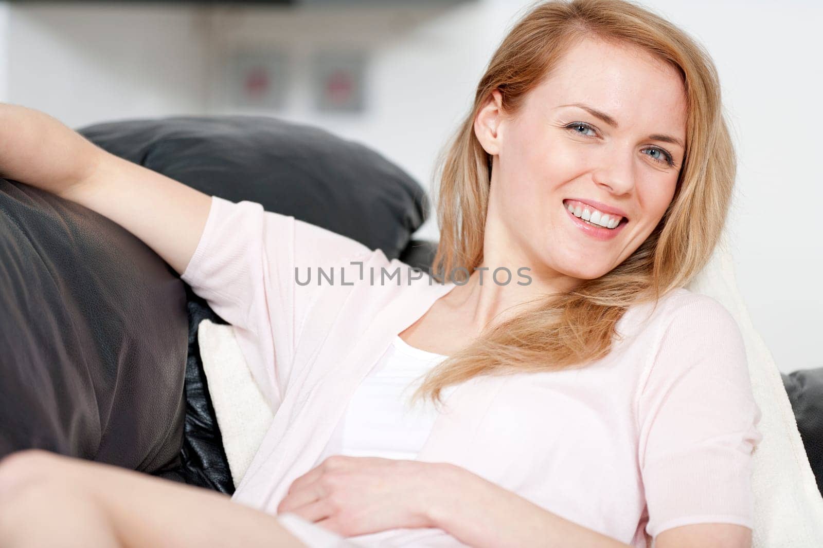 Young woman lying on sofa at home
