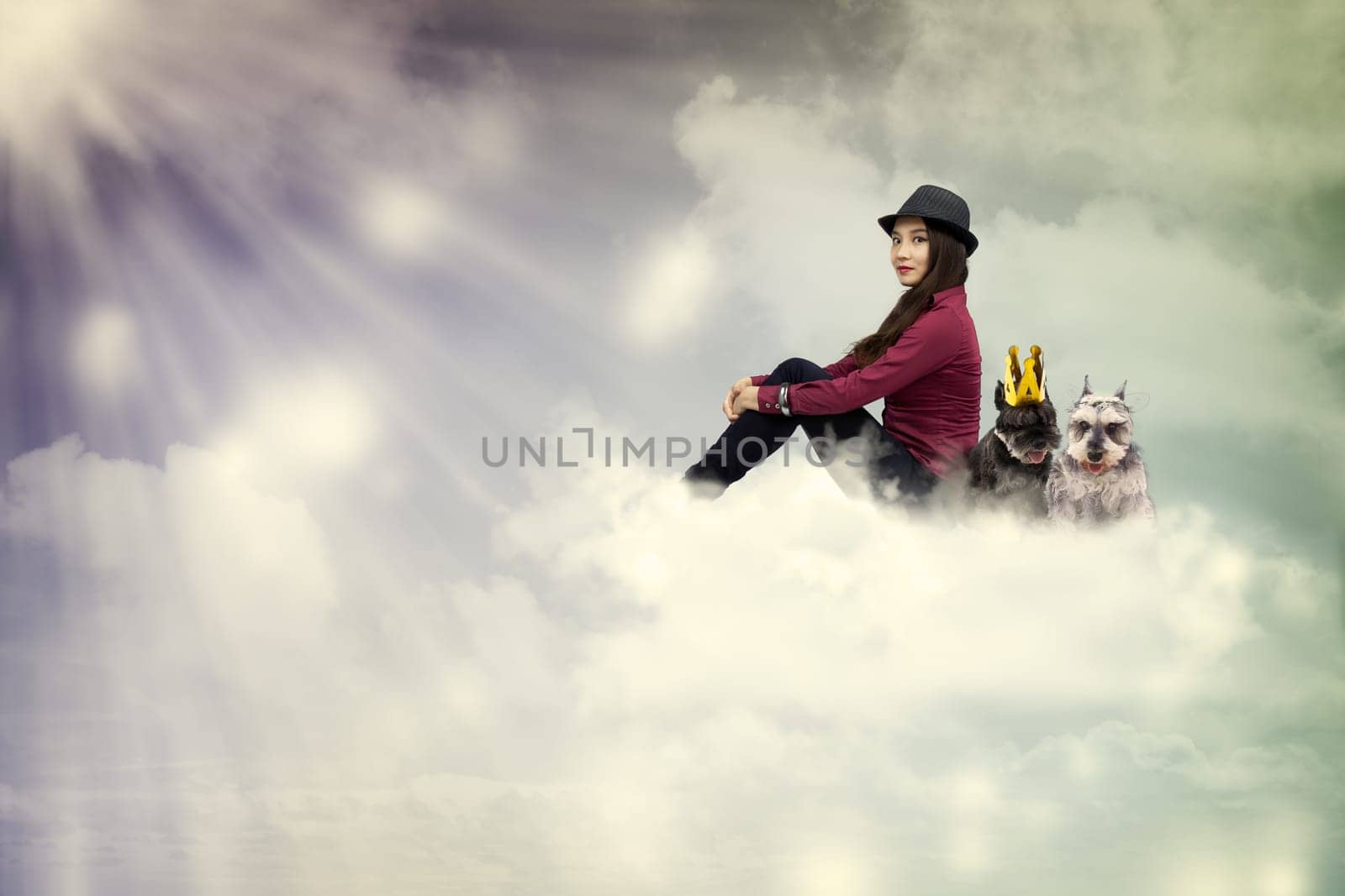 Young woman sitting on the cloud with dogs in vintage style