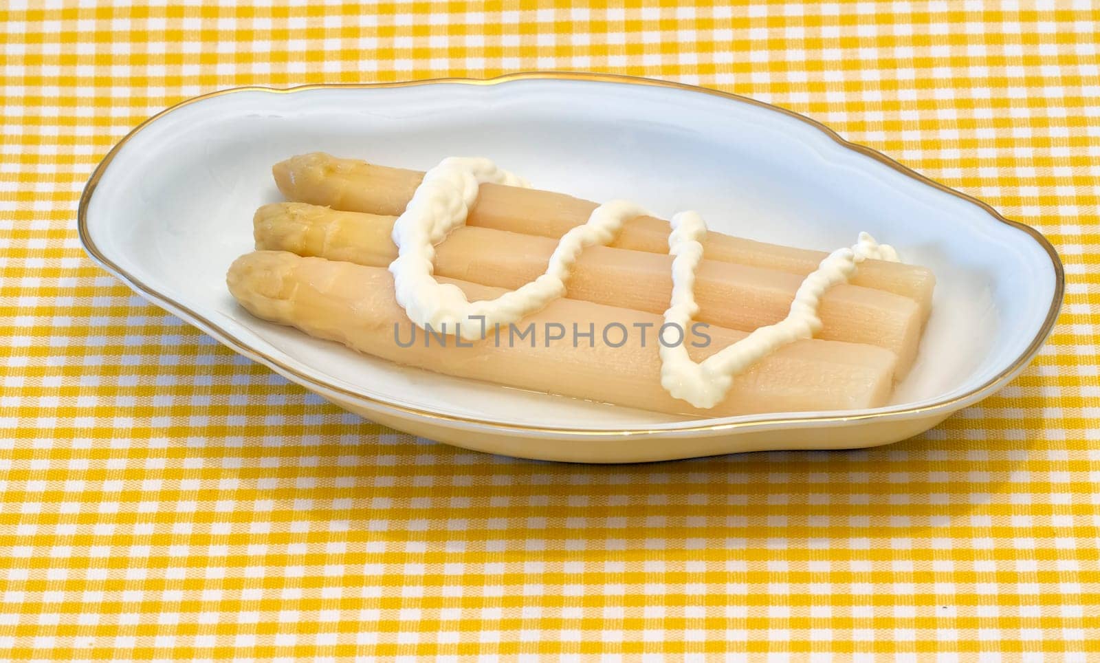 white asparagus from Navarra Spain, presented in decorated ceramic bowl with mayonnaise sauce
