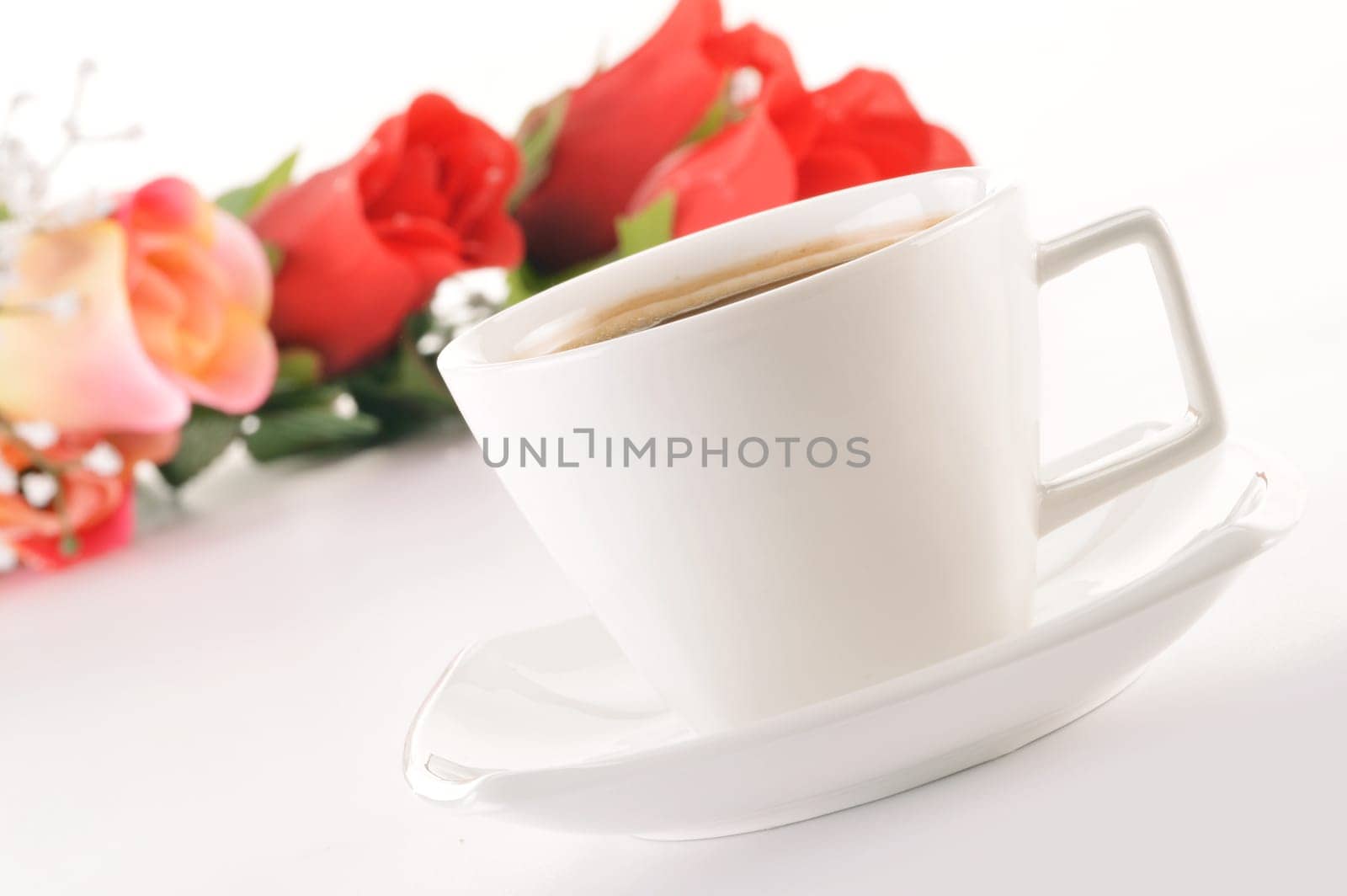Composition with white cup of coffee and bouquet of roses