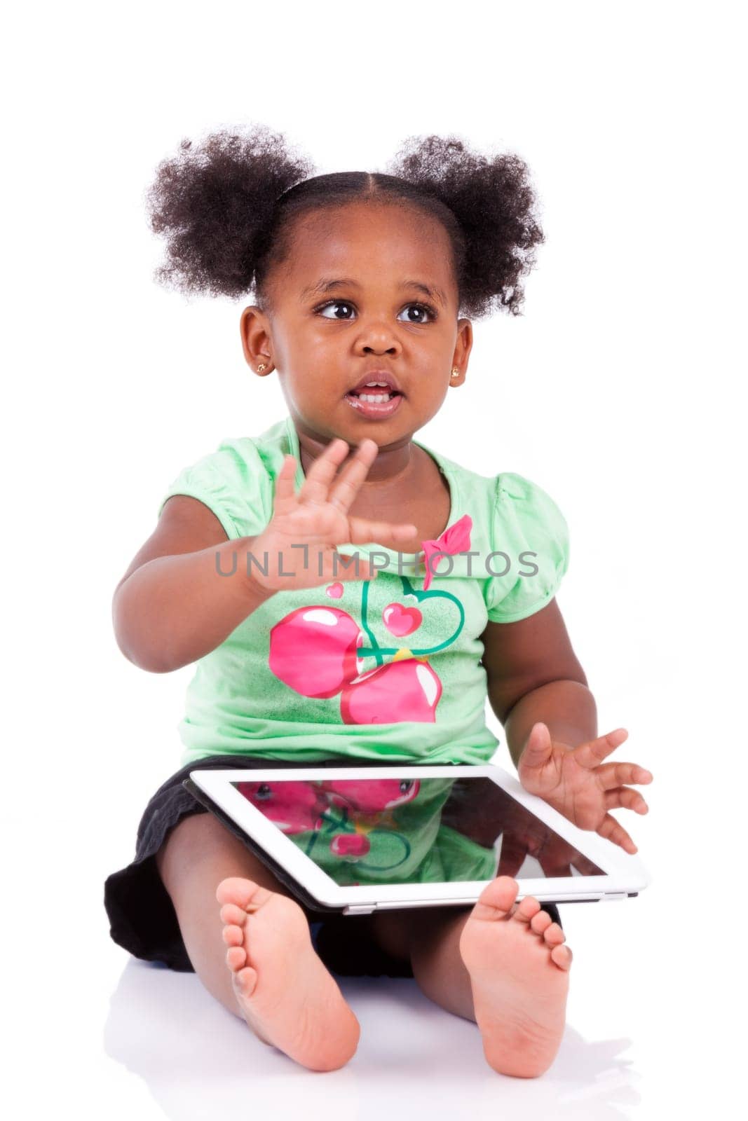 Little african american girl using a tablet  pc, isolated on white background