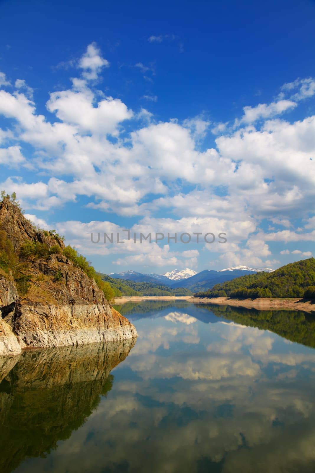 Beautiful landscape of Vidraru lake on a very peaceful day, Romania.