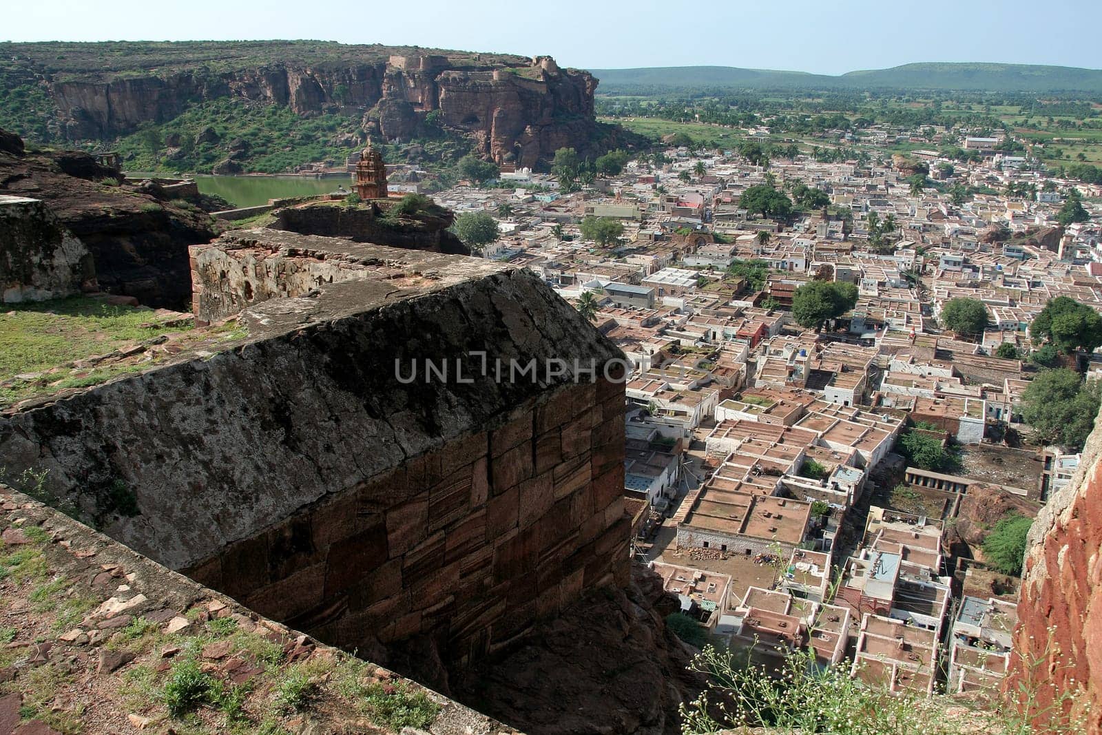 Aerial view of town with hilltop fort in the foreground at Badami, Karnataka, India, Asia