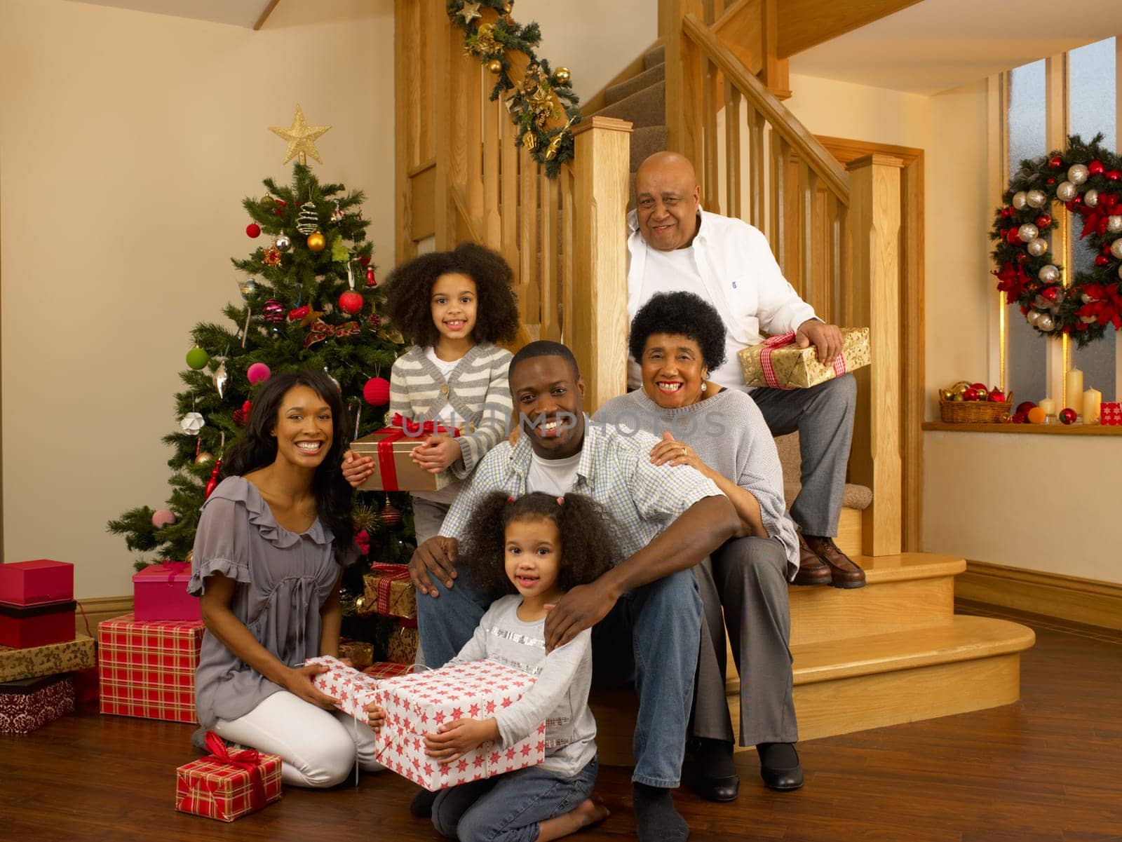 Mixed race family with Christmas tree and gifts