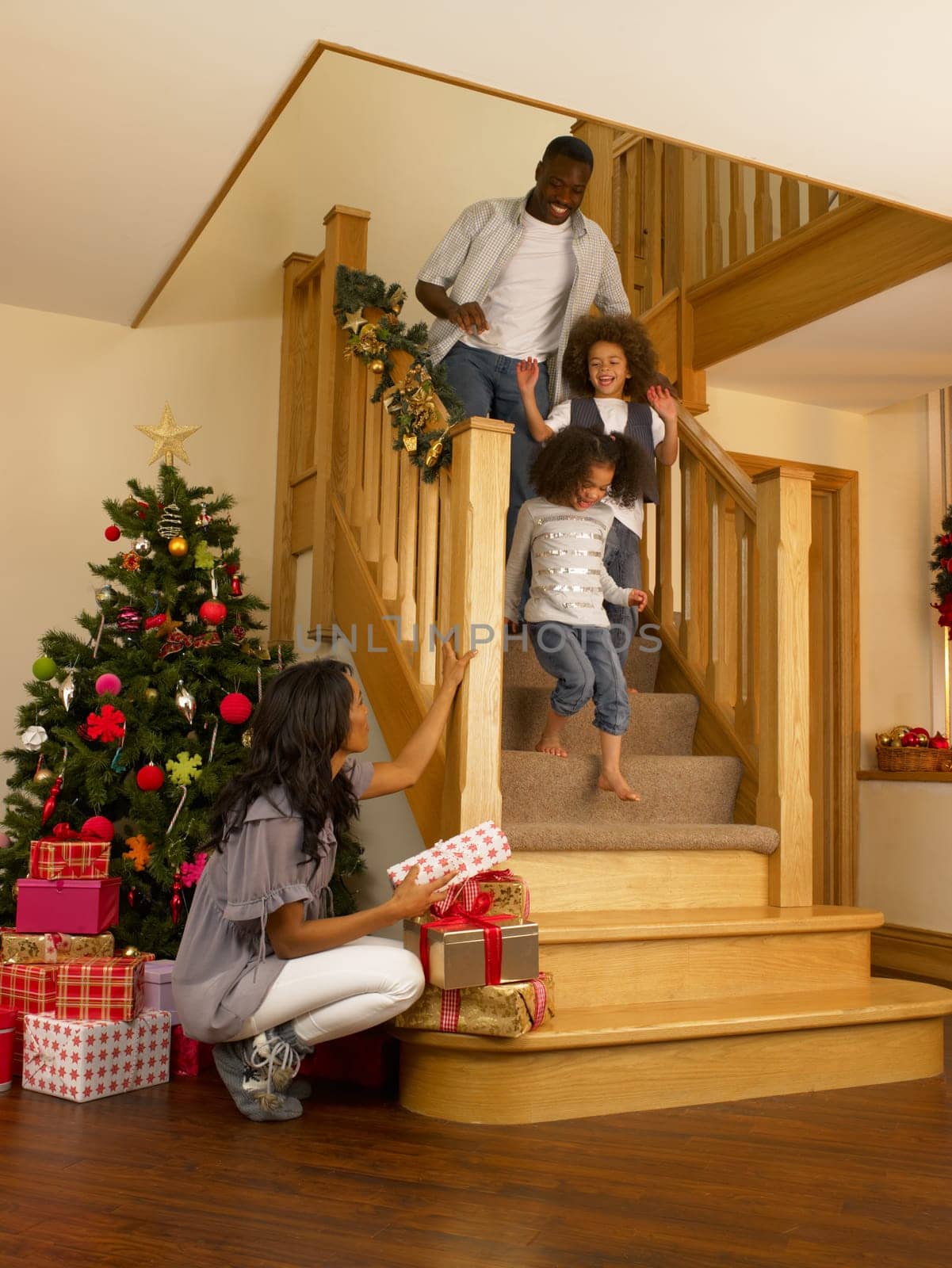 Young African American family on Christmas morning