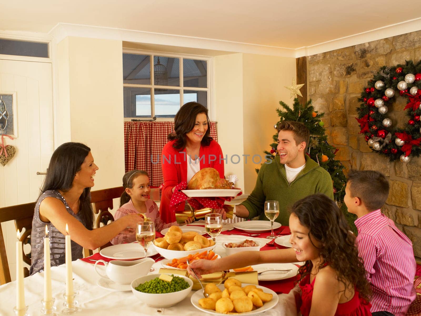 Hispanic family serving Christmas dinner
