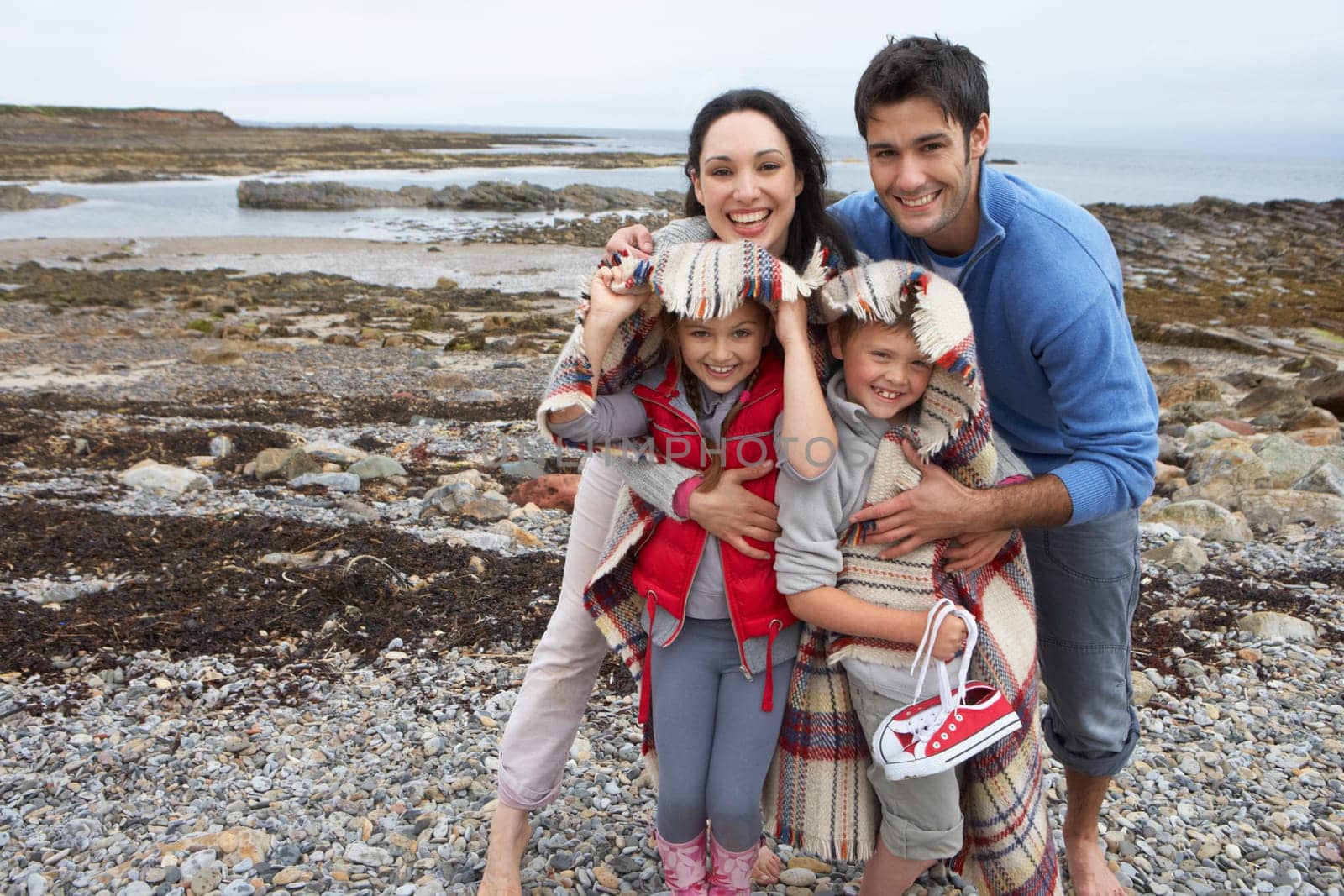 Family on beach with blankets