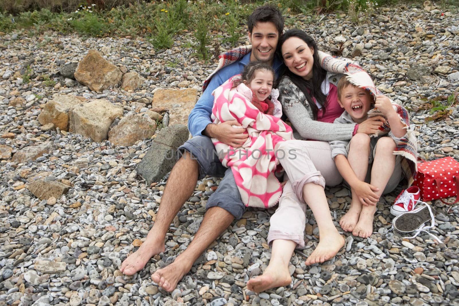 Family on beach with blankets