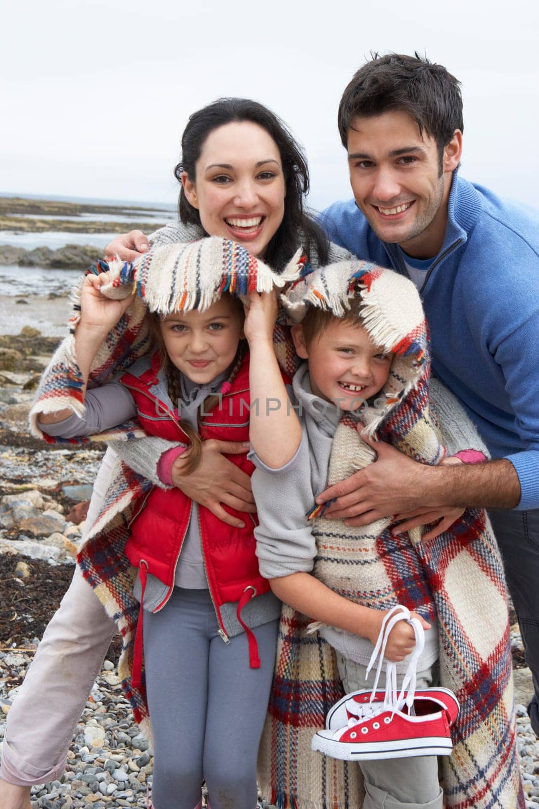 Family on beach with blankets
