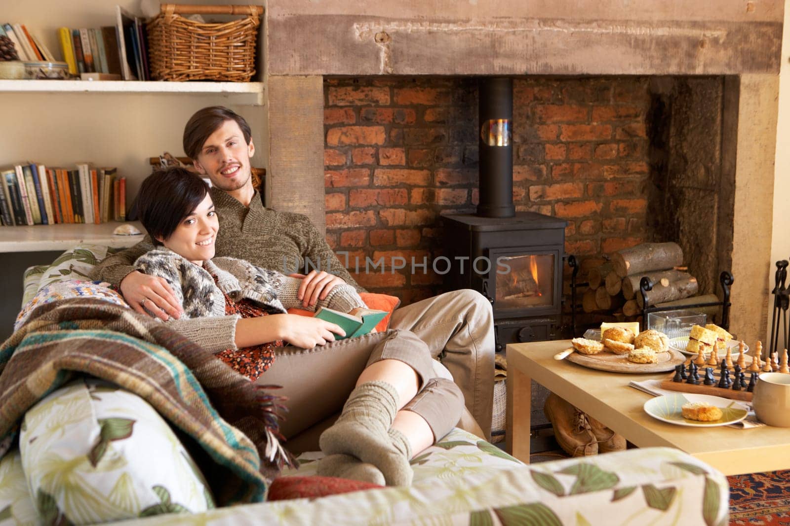 Young couple relaxing by fire