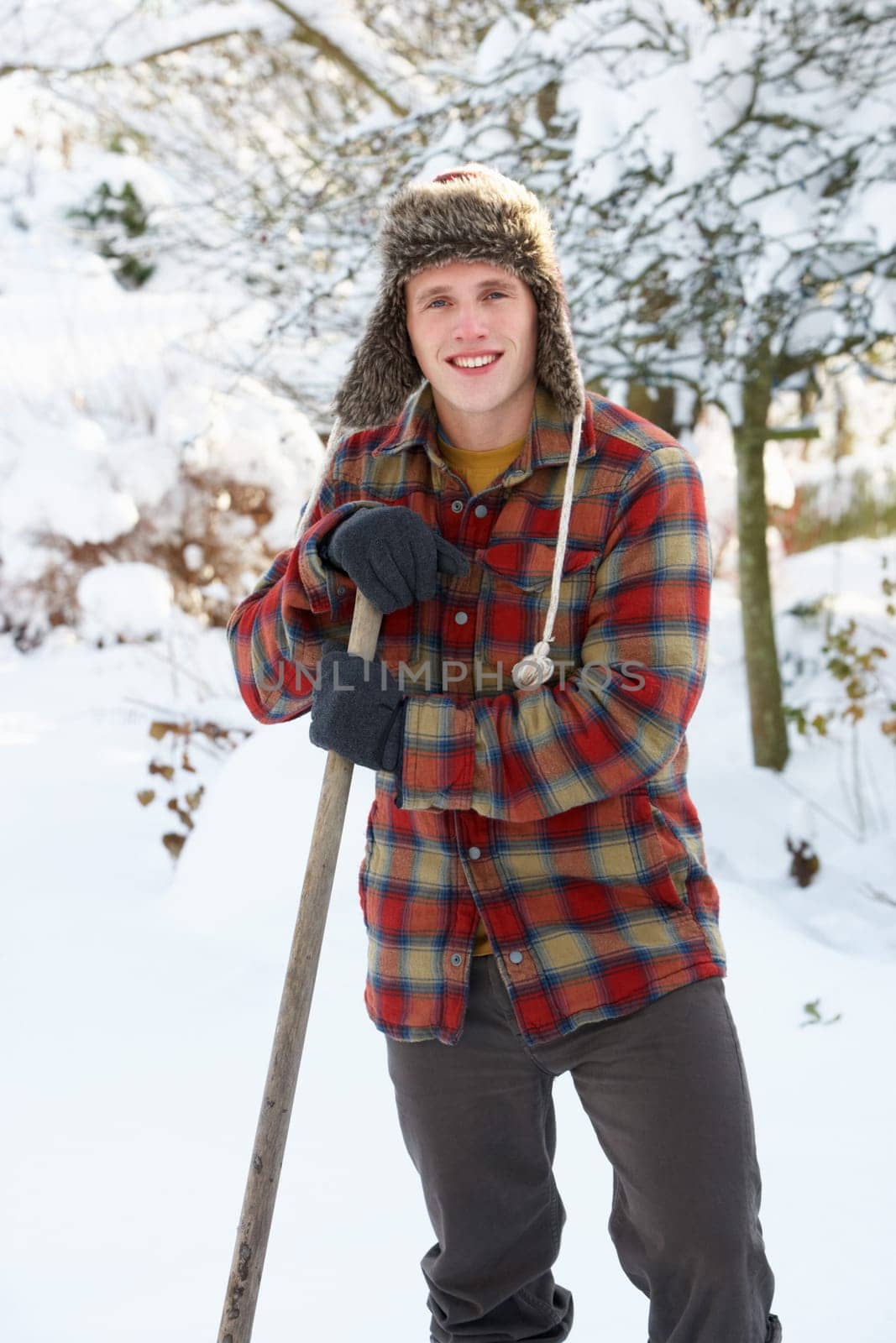 Young man clearing snow