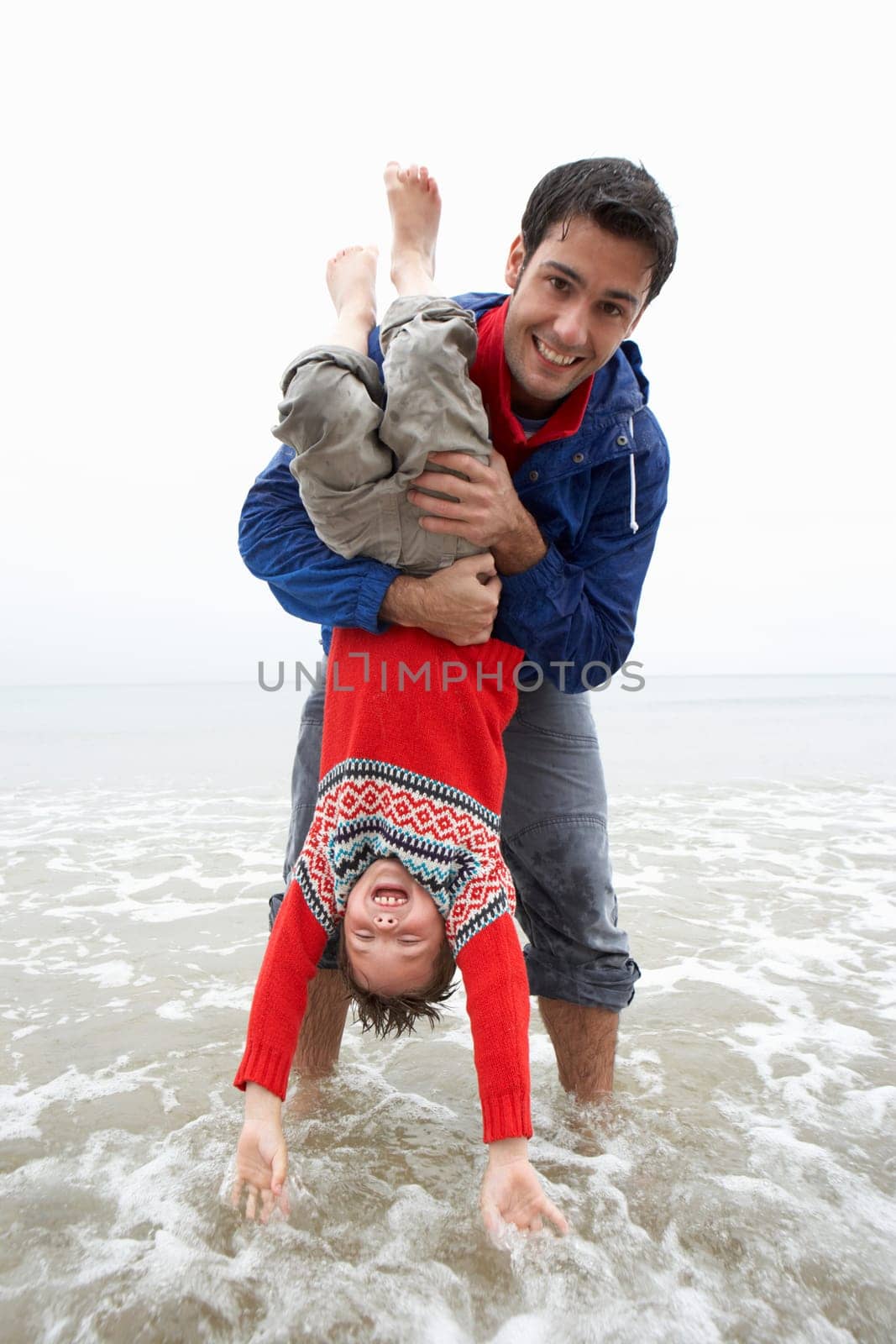 Happy father with son on beach