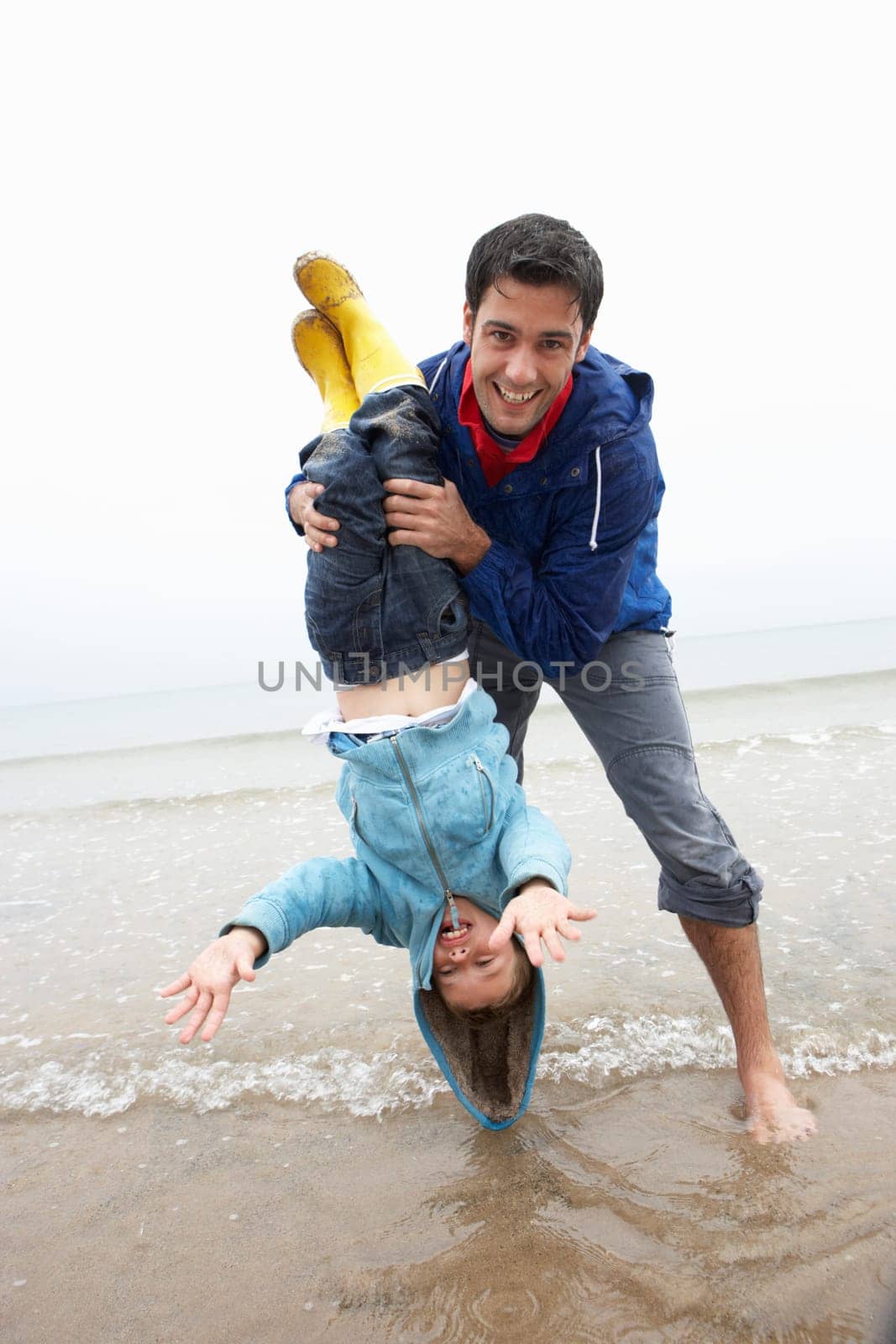 Happy father with son on beach