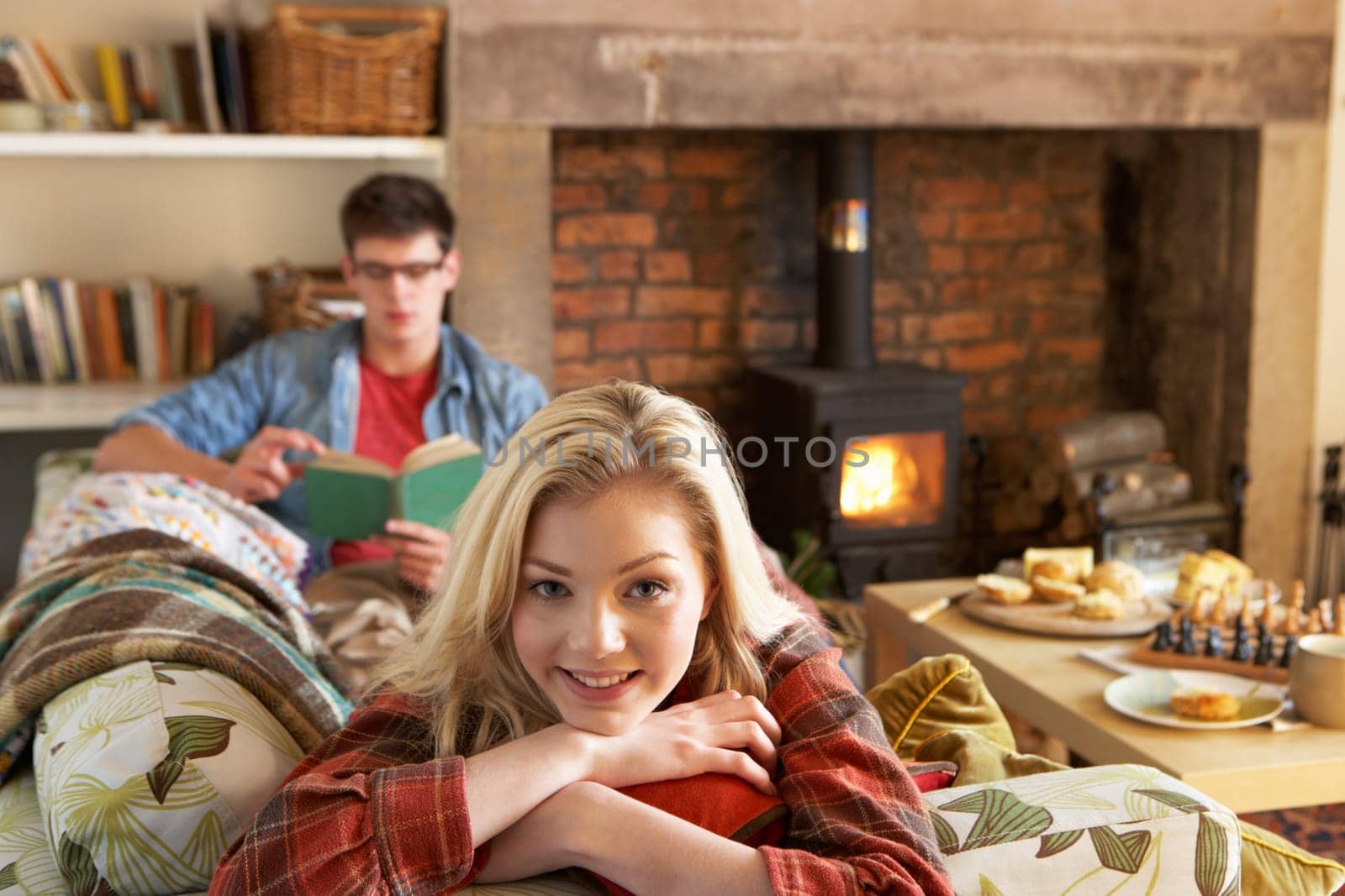 Young couple relaxing by fire