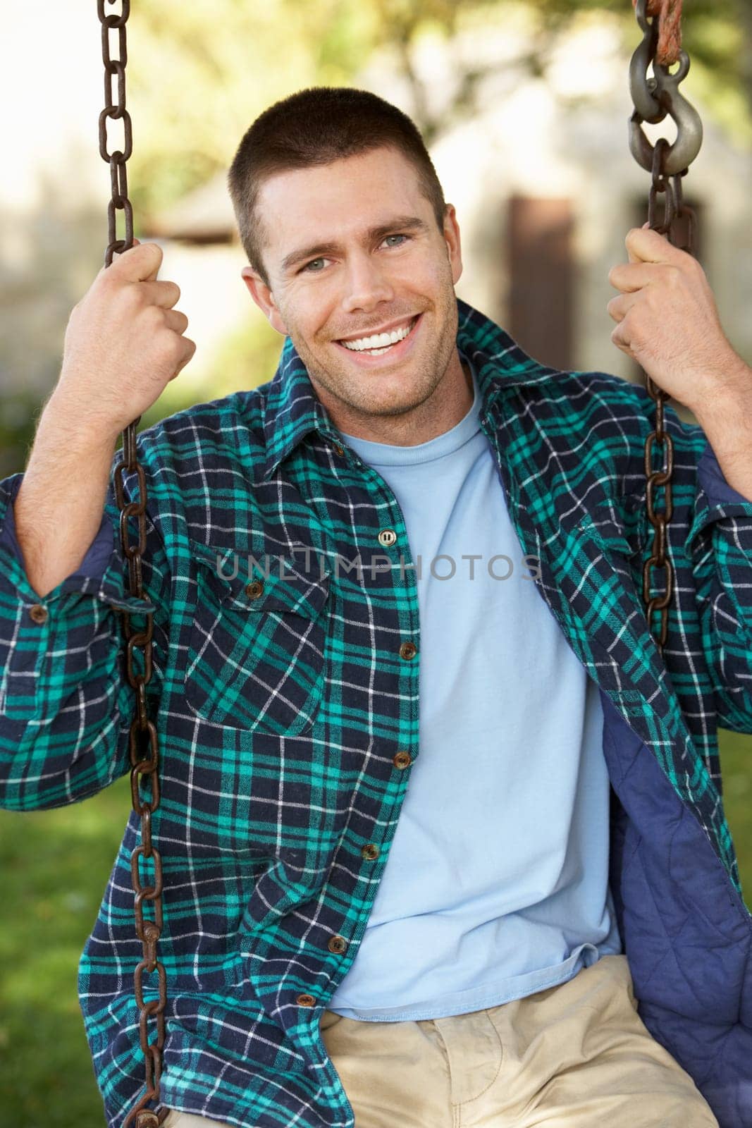 Man on country garden swing