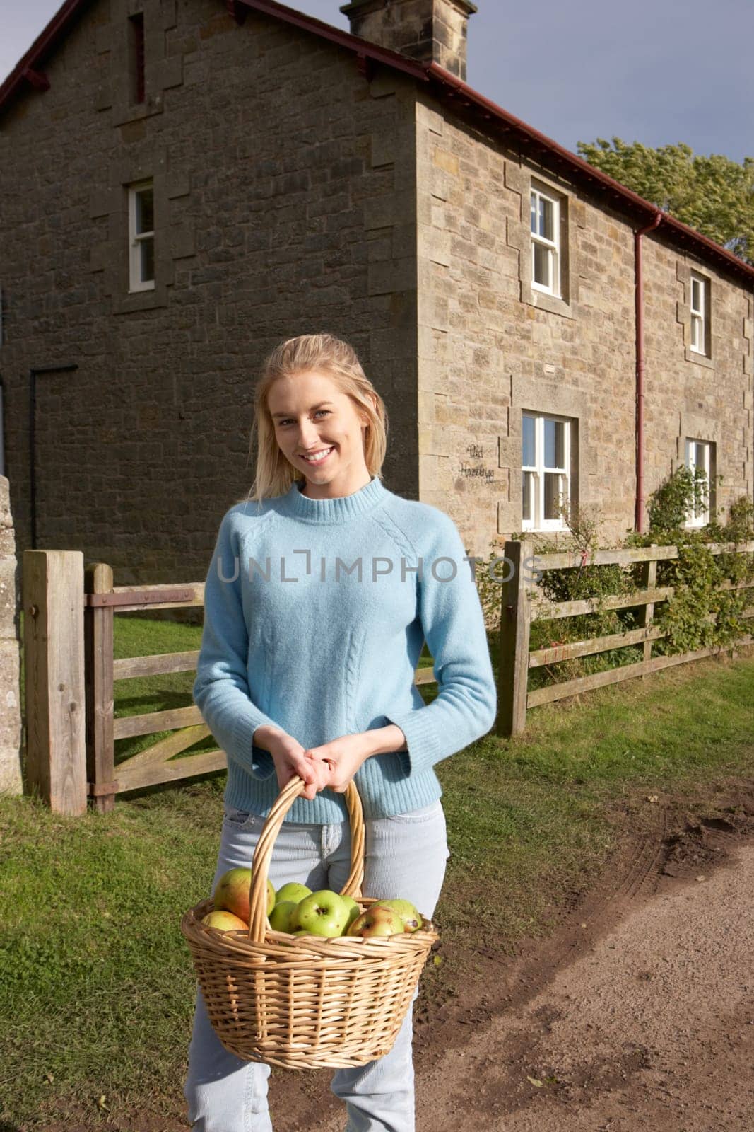 Young woman with basket of apples