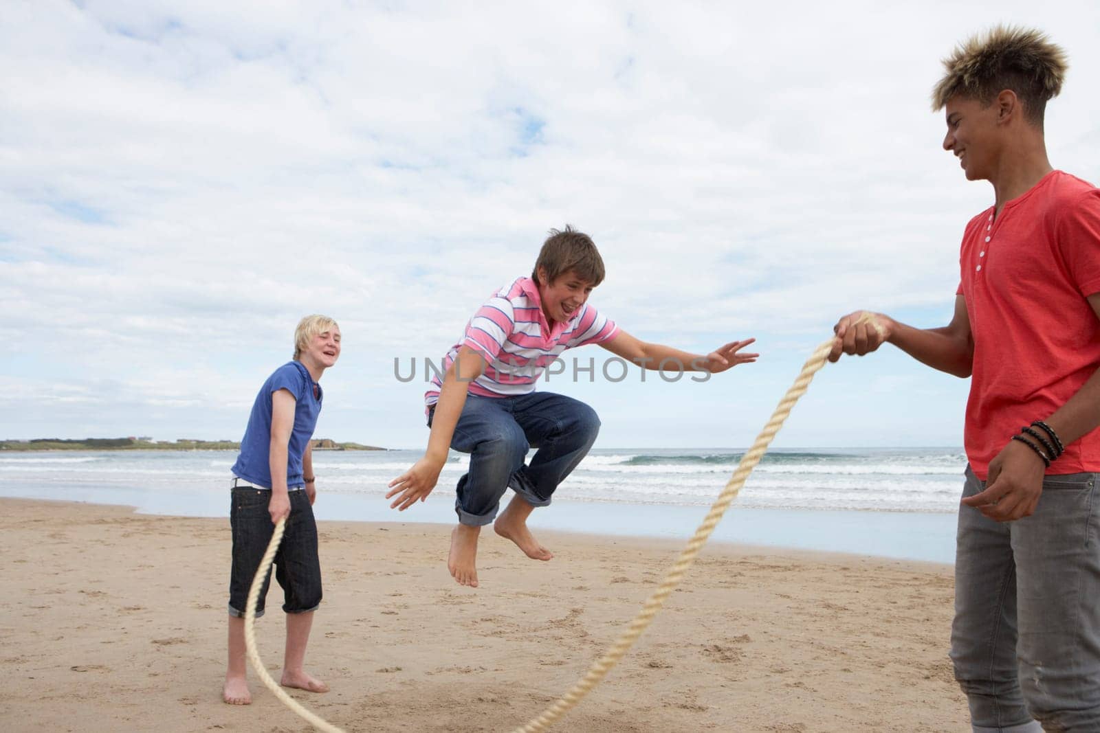Teenagers playing skipping rope