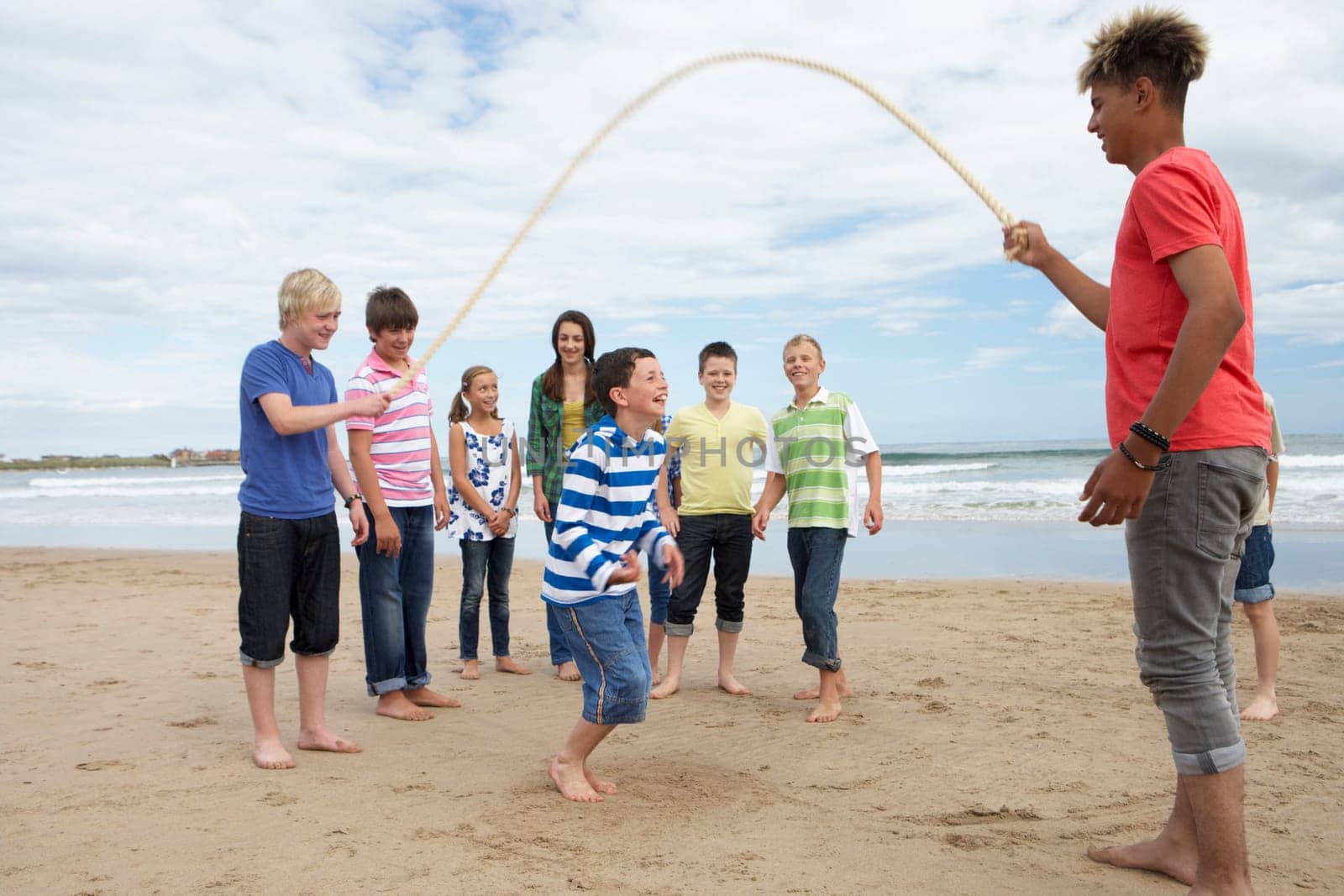 Teenagers playing skipping rope