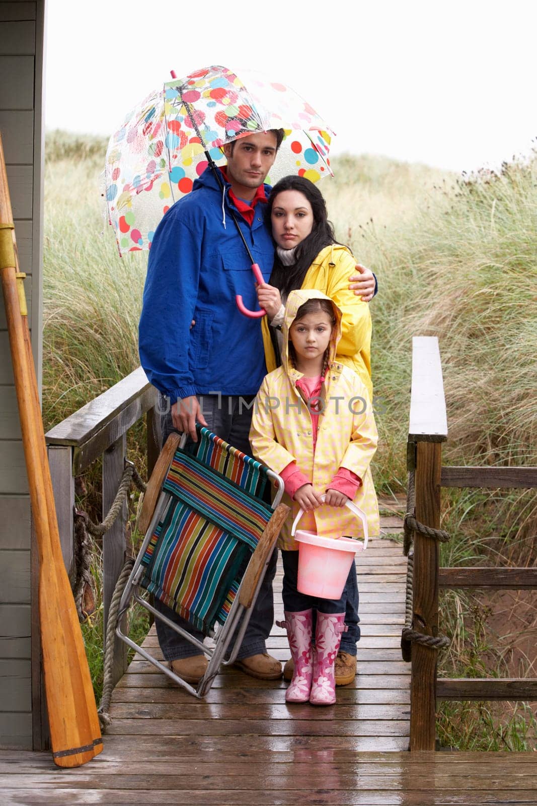 Family on beach with umbrella