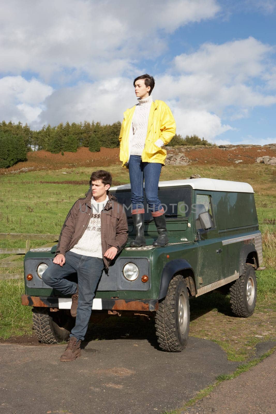 Young couple in countryside with SUV