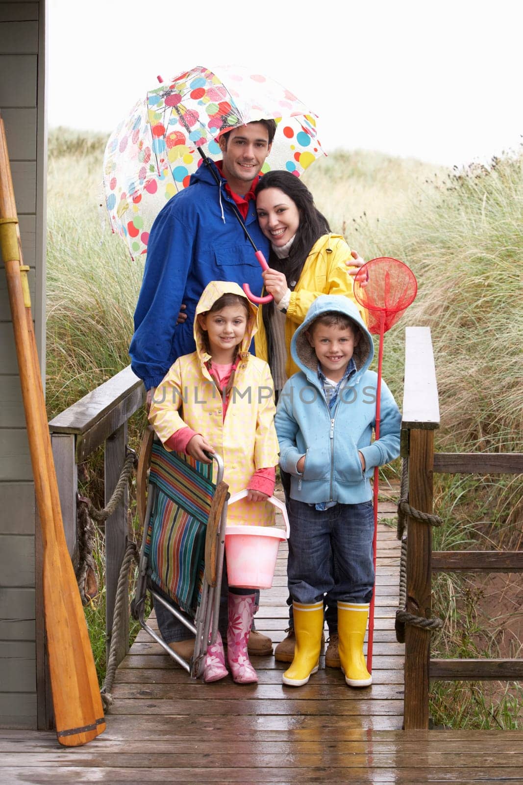 Family on beach with umbrella