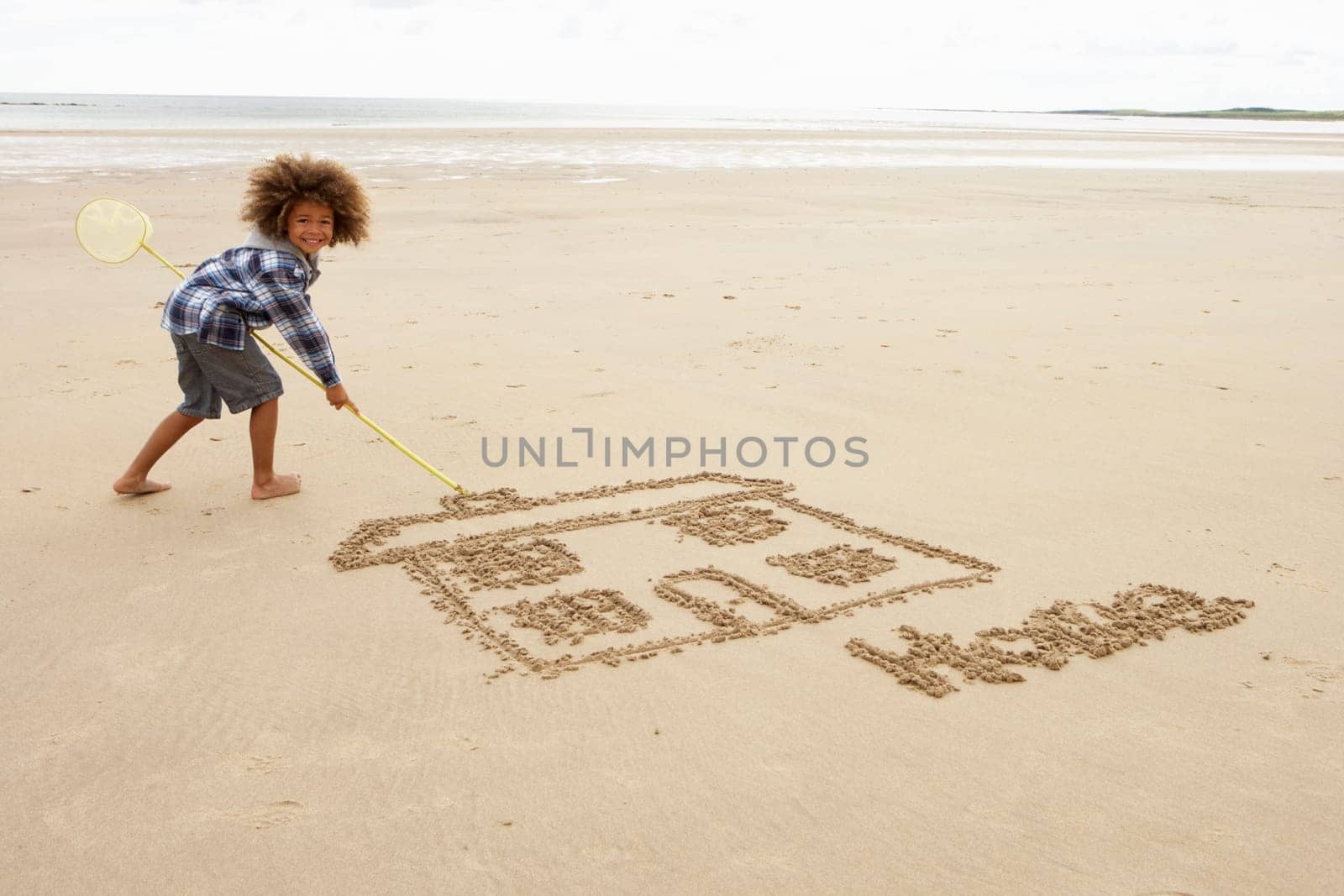 Boy drawing in sand