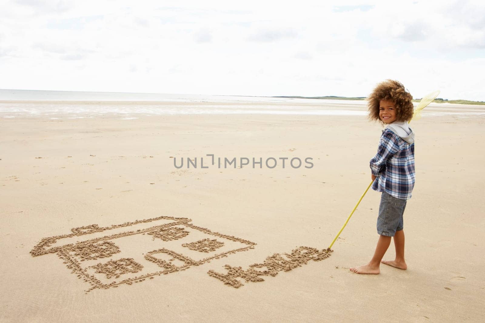 Boy drawing in sand