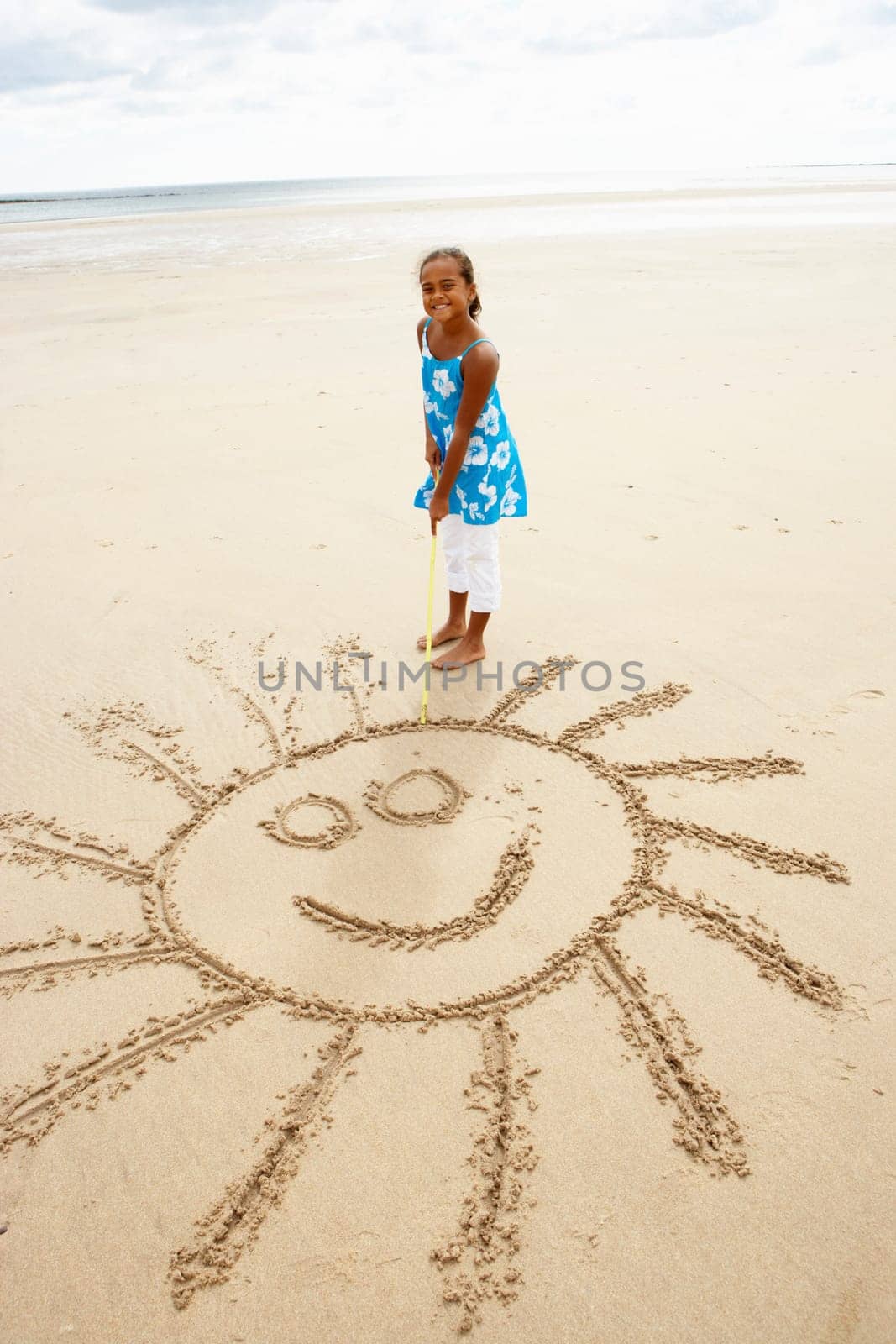 Girl drawing in sand