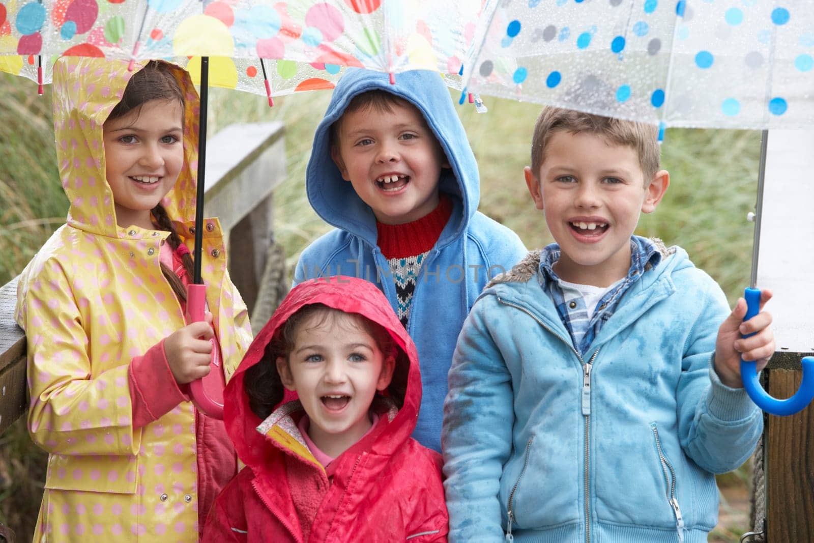Children posing with umbrella