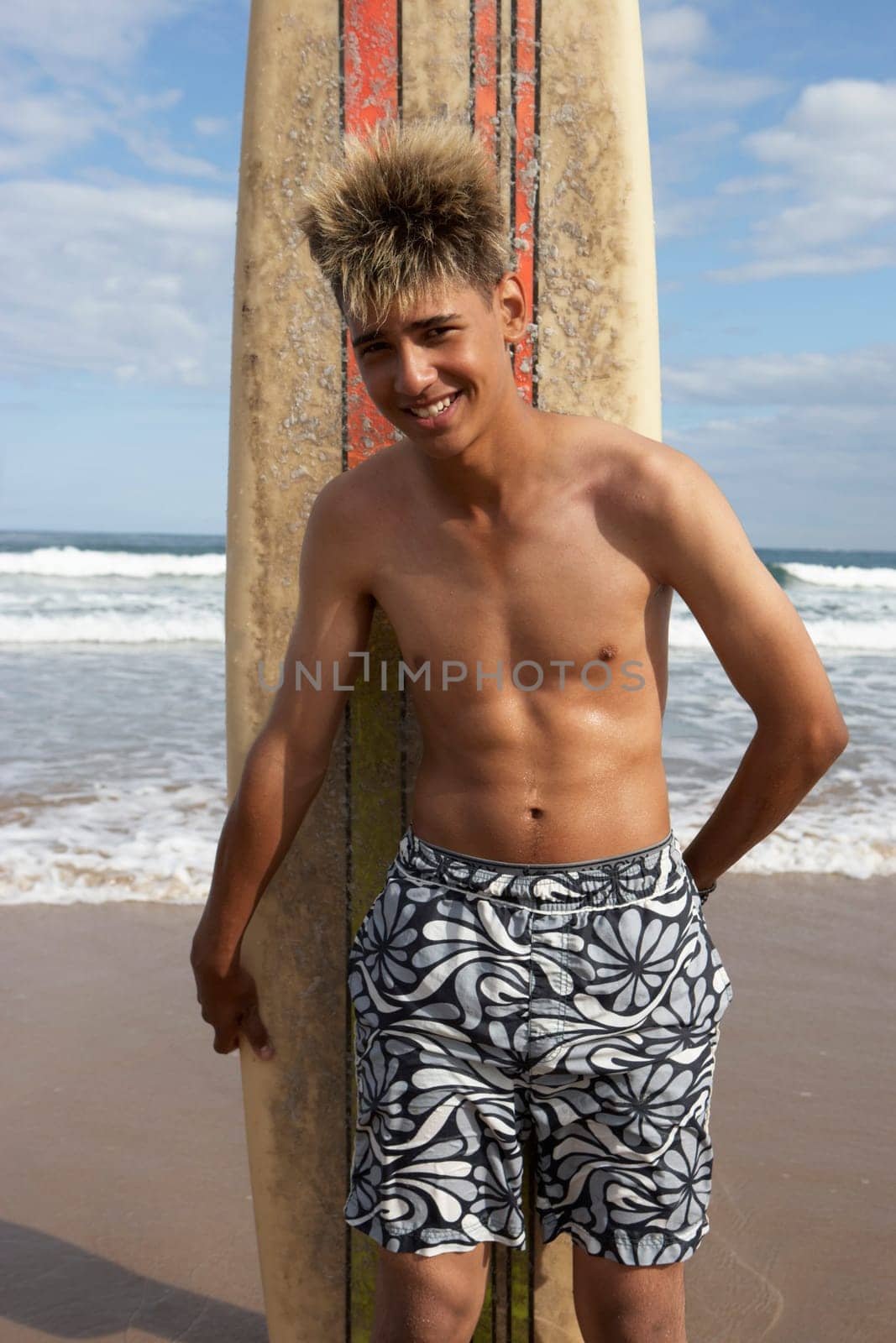 Teenage boy with surfboard