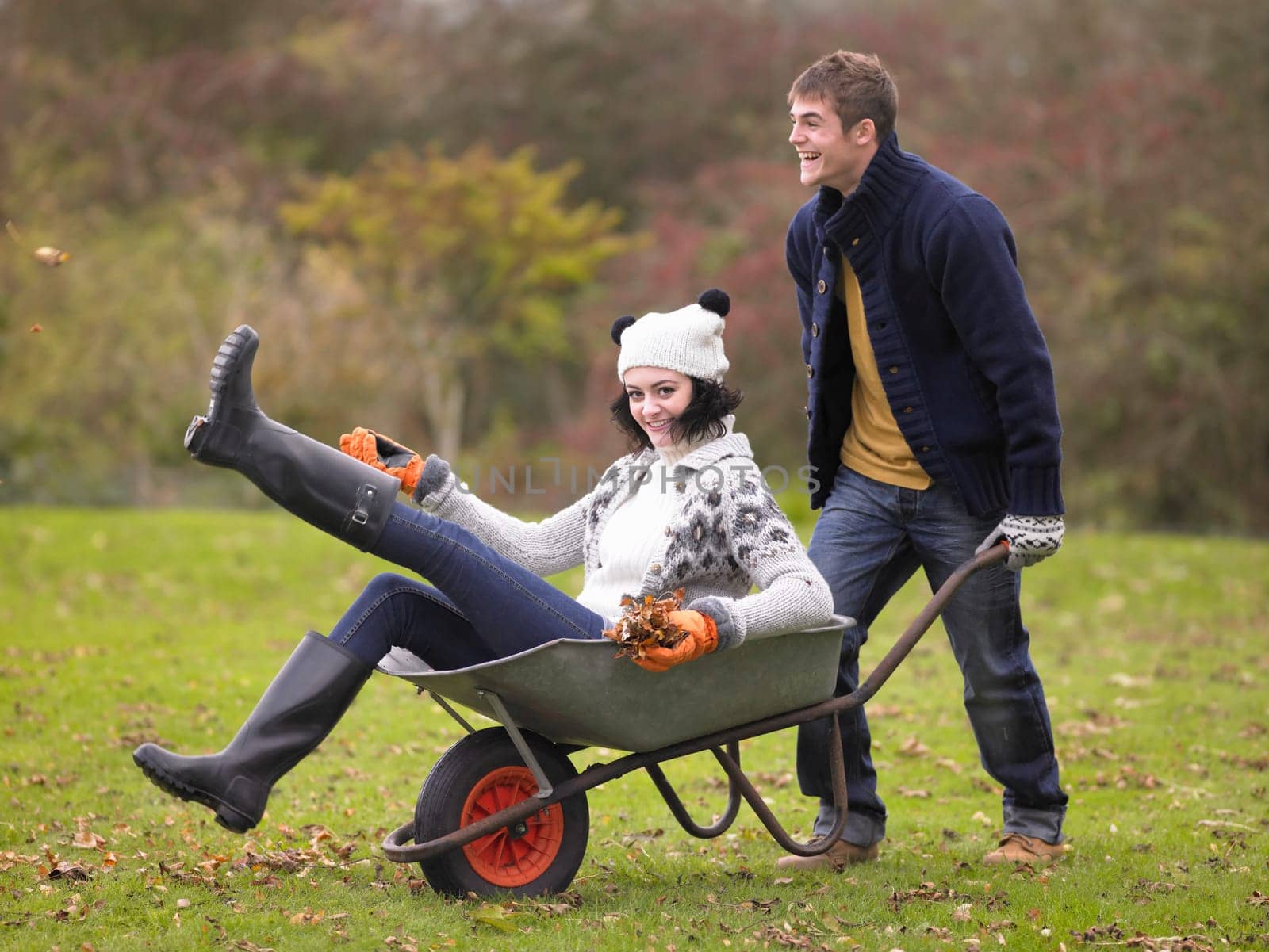Young couple playing in wheelbarrow