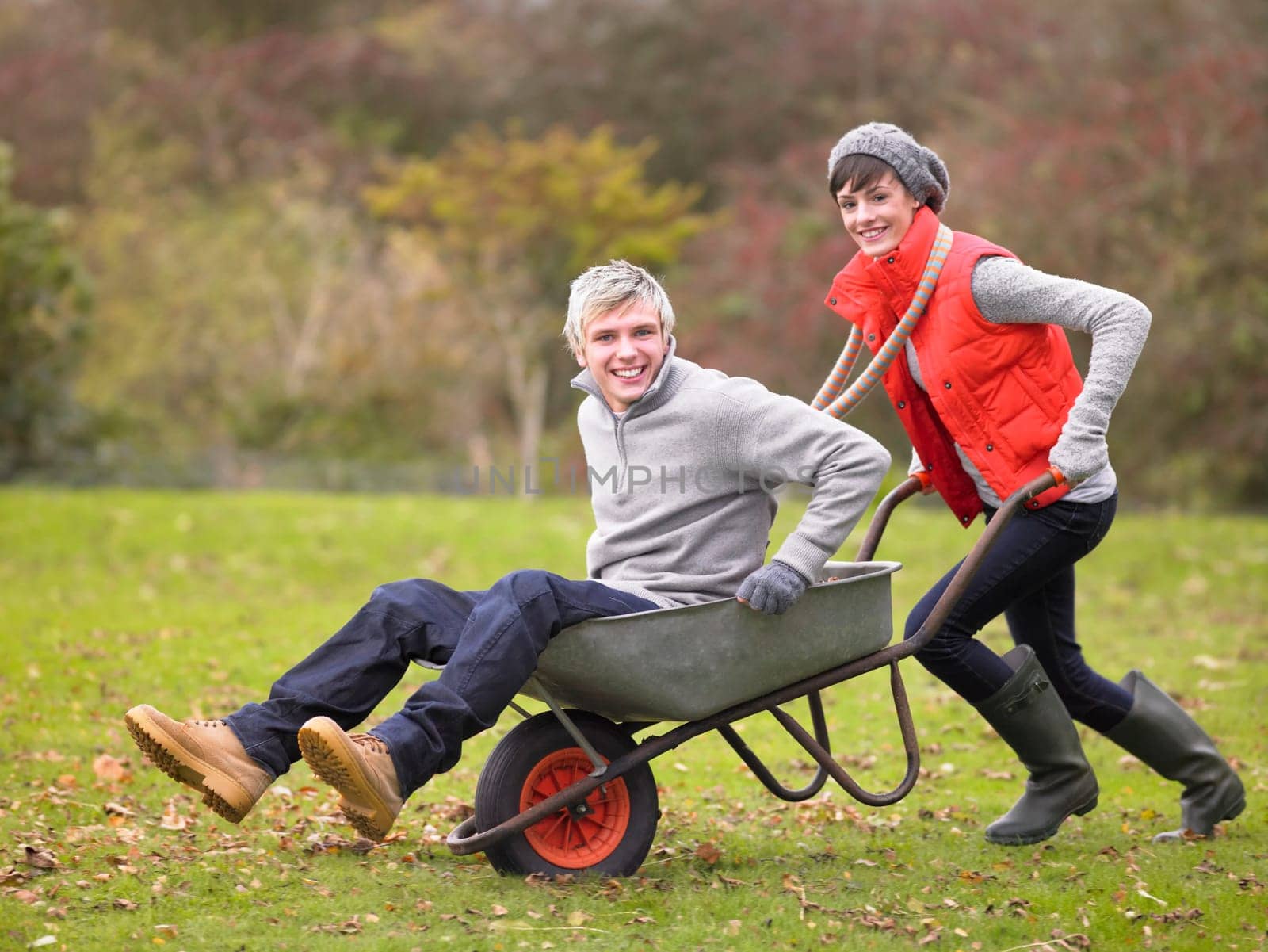 Young couple playing in wheelbarrow