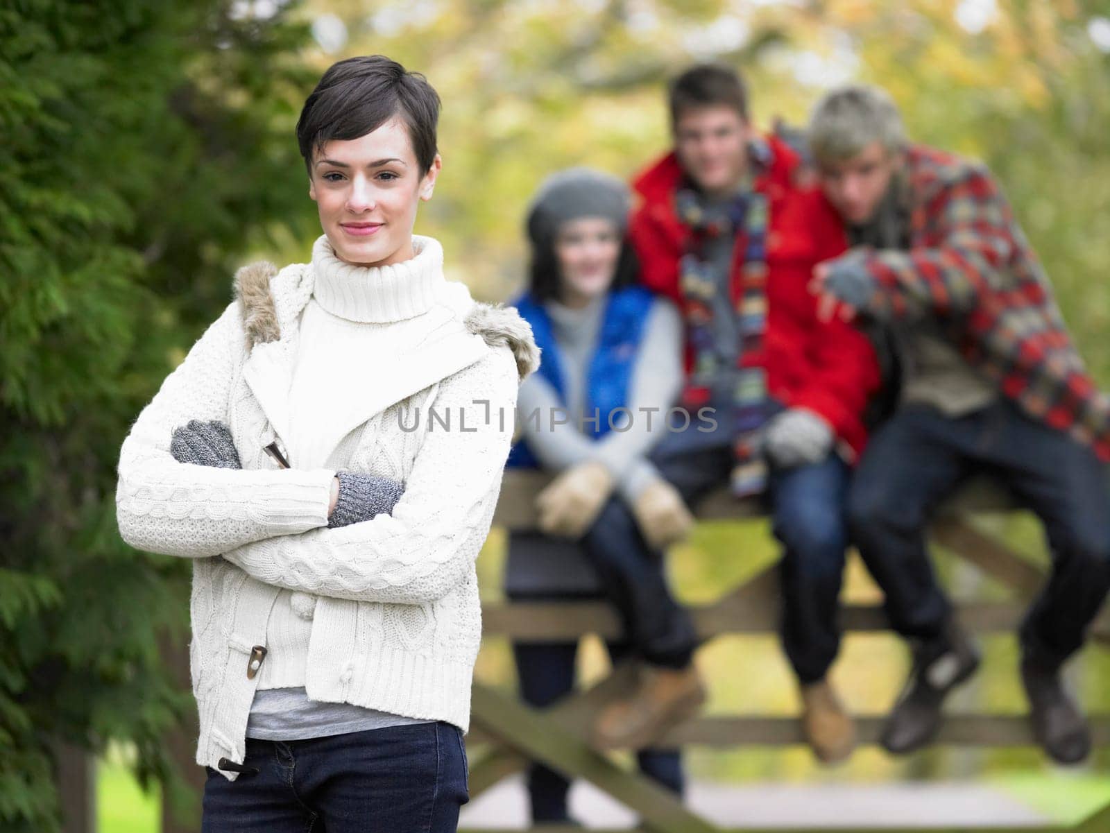 Young friends sitting on fence