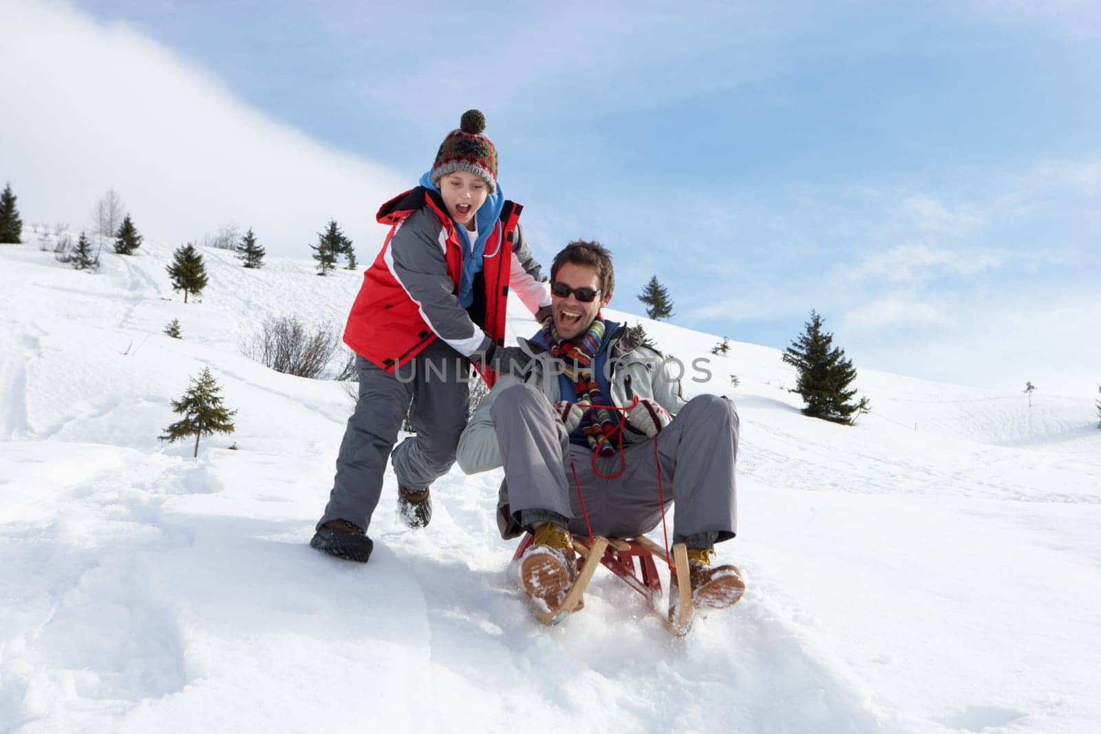 Young Father And Son Sledding